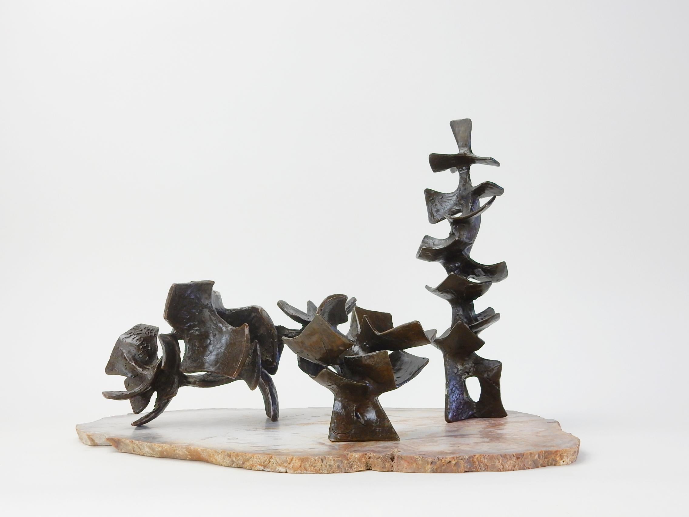 Set of 3 abstract solid bronze sculptures arranged on a thinly sliced petrified palm root slate.
Organic shapes in the style of sculptor Henry Moore.
Each is signed G. W. Hall and dated 1958 and 1959.
Tallest is 13 inches tall.

     