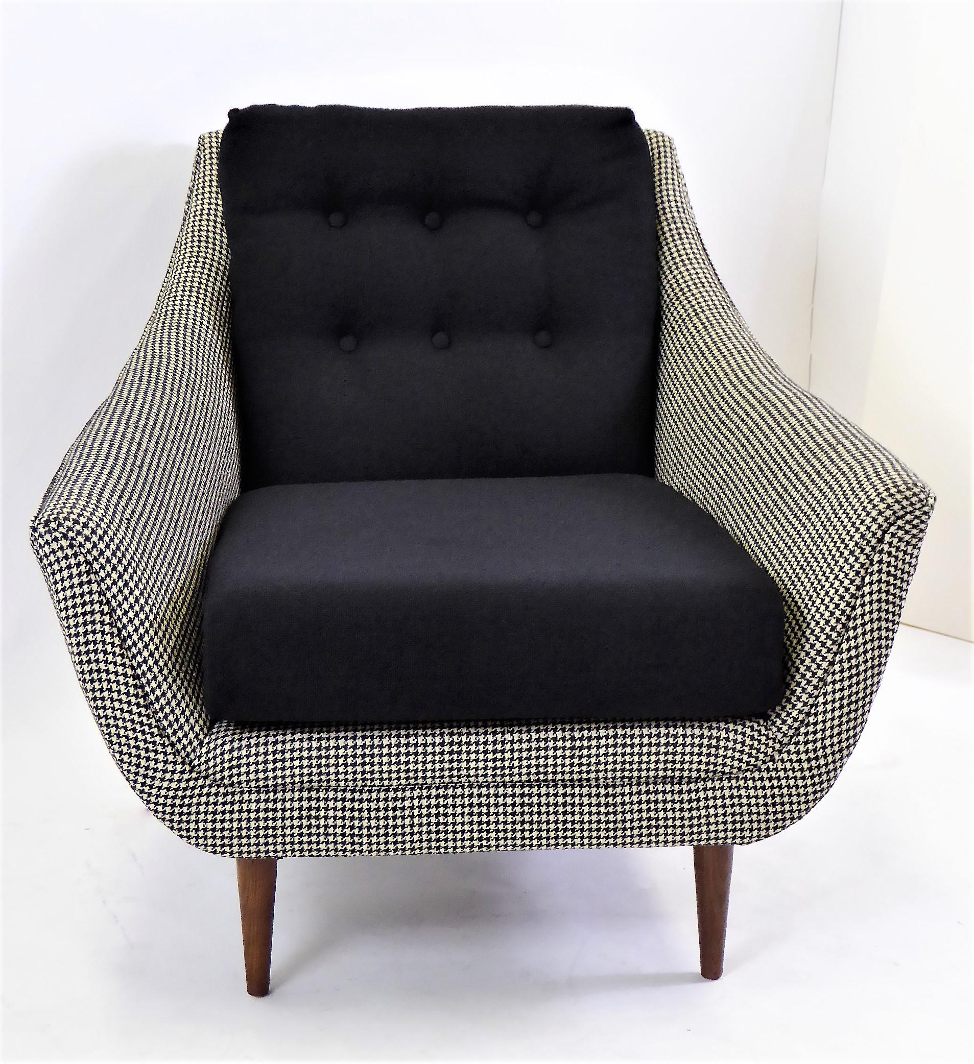 Lovely 1950s styling highlight this Adrian Pearsall lounge chair. Now upholstered in a houndstooth weave and a black tight hopsack weave. Great tapering walnut legs. A comfortable scoop styling.

Measurements: 32 inches wide at front x 23 inches