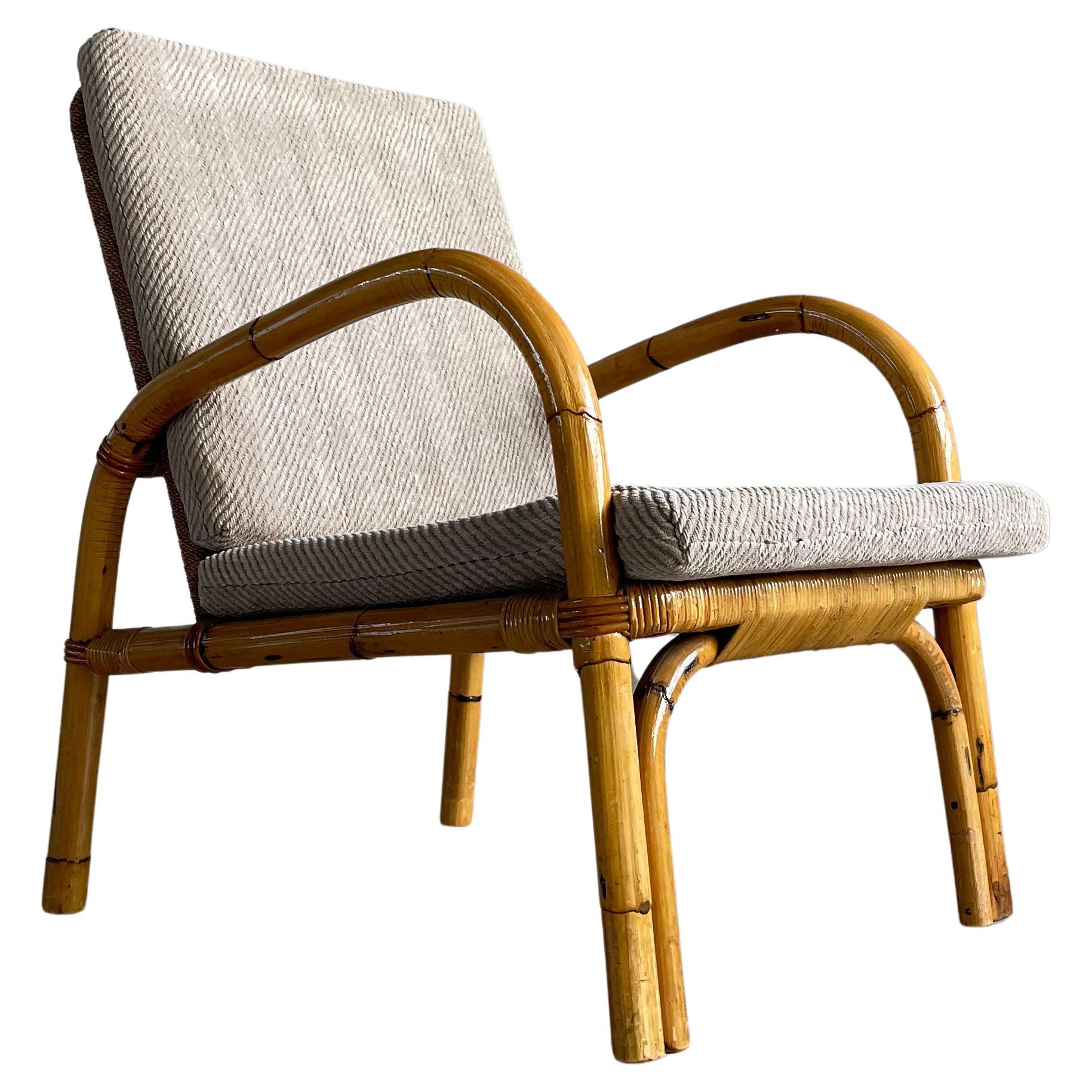 1950’s Adrien Audoux & Frida Minet Bamboo Armchair with rattan and braided rope backrest. Beige woolen upholstered seat and rear cushions. In prime original condition.
Design: Adrien Audoux & Frida Minet, 1950 - 1959