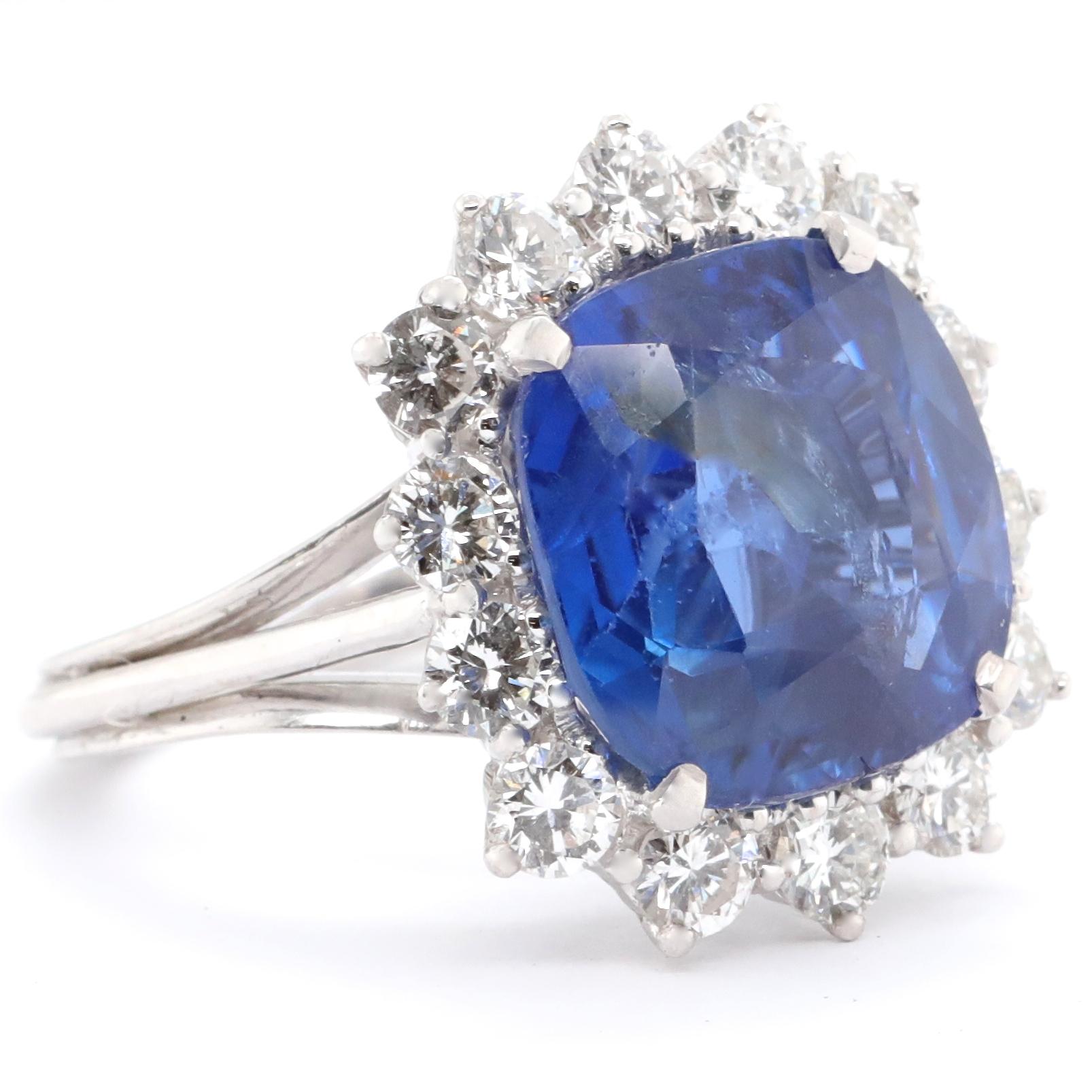 This ring just speaks ROYALTY. Something a princess might wear to a soiree. The center stone is AGL certified as 9.75 Carat Ceylon No Heat Sapphire. Graciously accompanied by 14 round brilliant cut diamonds approximately, 1.50 carat G-H color, VS