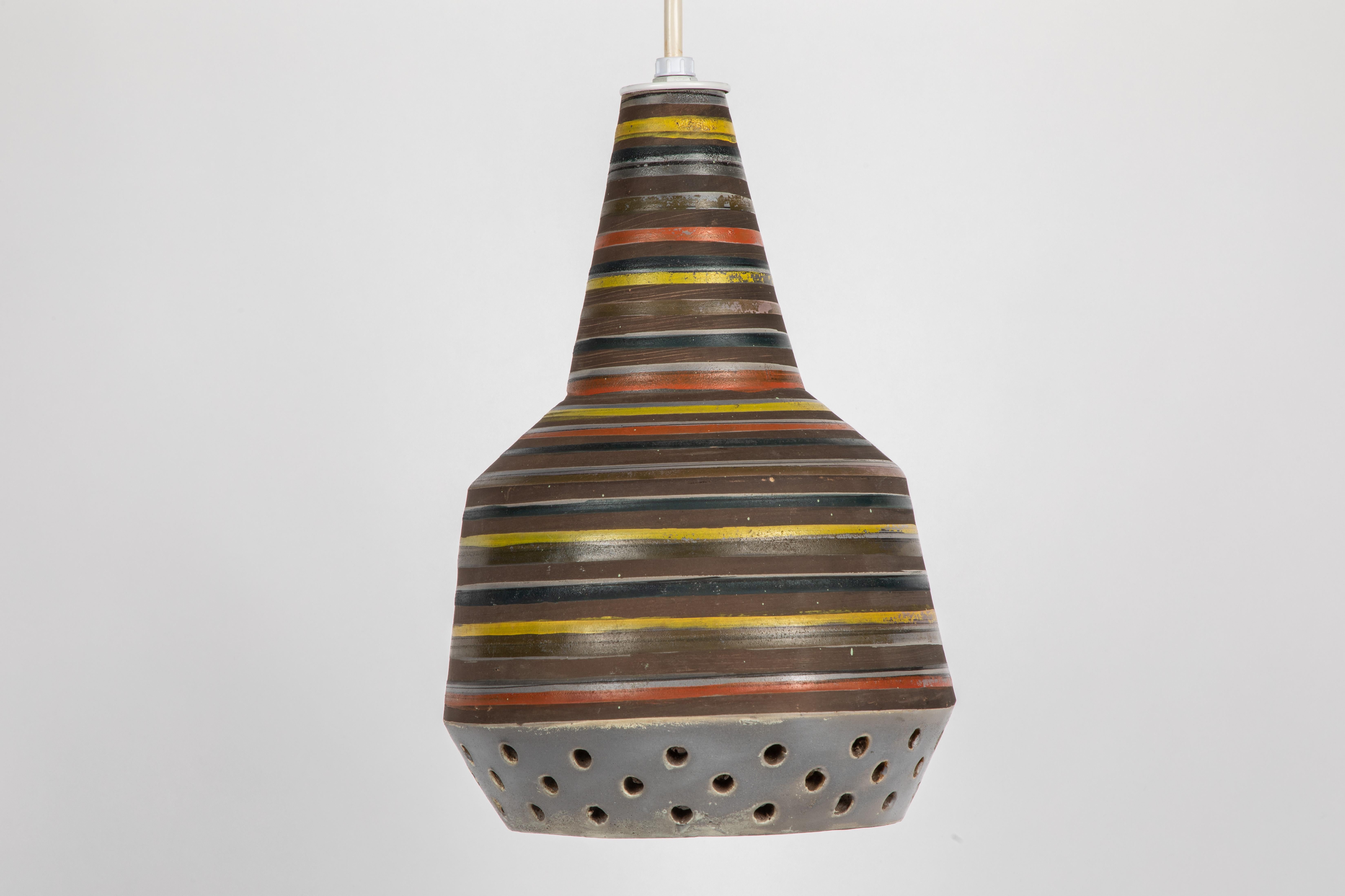 1950s Aldo Londi Ceramic Bitossi pendant lamp for Italian Raymor. This rare and sculptural Italian ceramic lamp is executed with multi colored glazed horizontal stripes and geometric circular perforations. 

Only one available in this coloration.