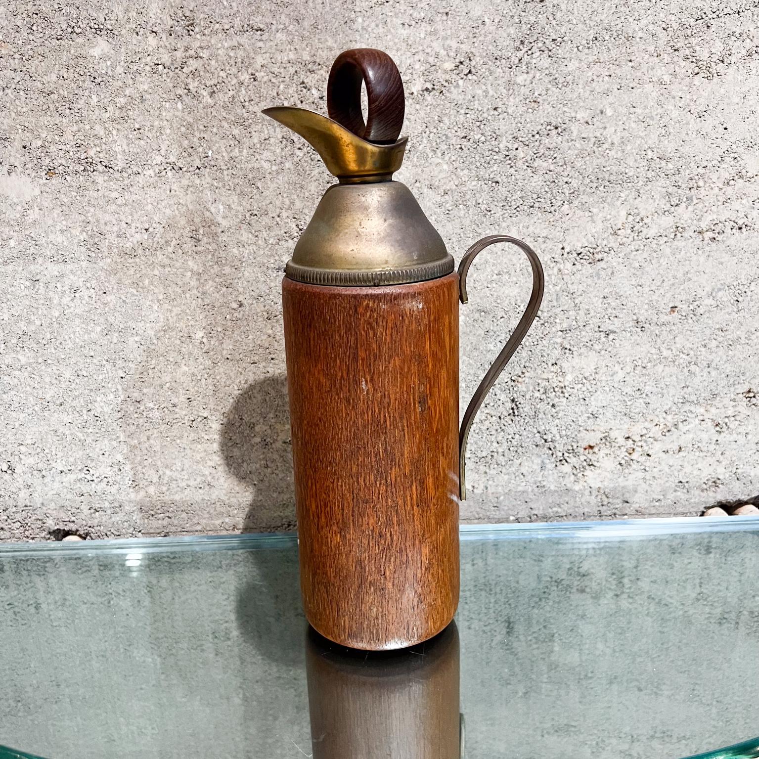 1950s Italian pitcher (carafe thermos) by Aldo Tura ITALY
Designed in Brass and Teakwood.
Unmarked.
Measures: 12.5 tall x 3.75 diameter x 5.25 depth
Brass & wood have vintage patina. 
Original cork is missing and replaced with vintage