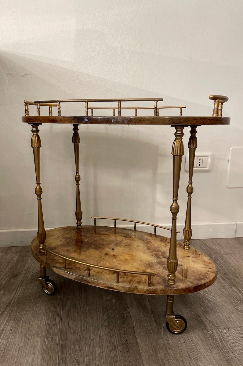 1950s cart made by Aldo Tura from glazed parchment and brass frame. 

The trolley has the original wheels; a conservative restoration was done to maintain the characteristics of the period. 

Each shelf and the structure have many details made of
