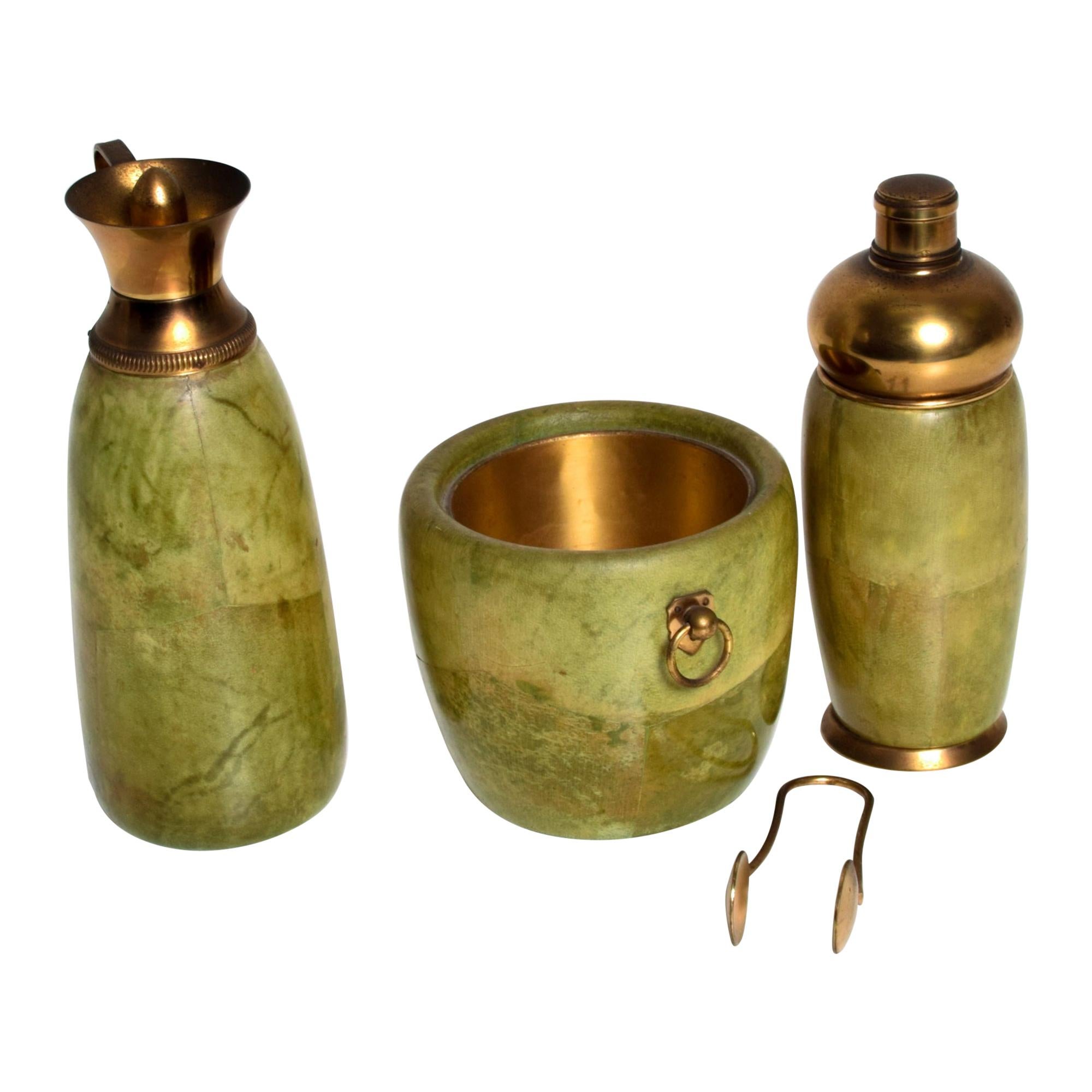 AMBIANIC presents
Mid Century Aldo Tura Macabo Barware Cocktail Set made in Italy circa 1950s. 
Solid wood wrapped in goatskin. Original elegant green finish. Brass accents with original vintage patina.
Aldo Tura Macabo Bar Set: includes ice bucket,