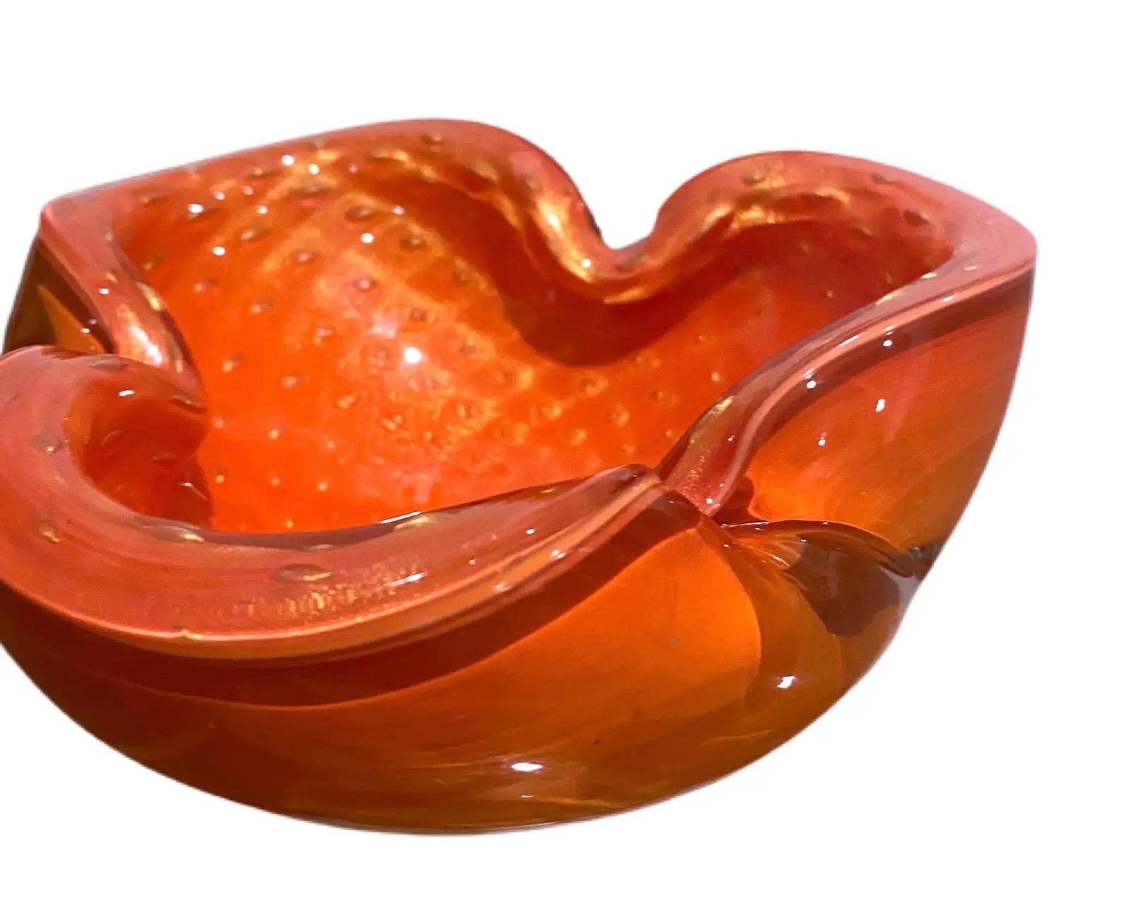 A Murano Cased Orange Glass Bowl with heavy Gold Flecks, by Alfredo Barbini. 1950s. Organic shape, flat ground and polished base.Orange and Colorless glass, layer of suspended gold flecks and controlled bubbles. 
Thick and heavy, very fine vintage