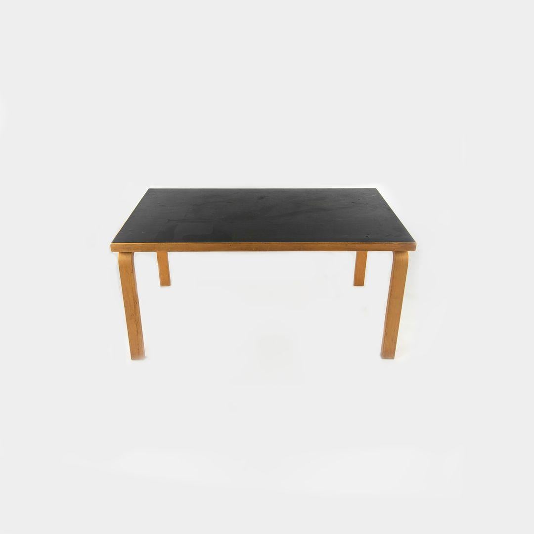 This is a child‚Äôs table (or can be used as a coffee table), model 81B, designed by Aino and Alvar Aalto for Artek in 1933. It was manufactured in Finland circa 1950s. The piece is constructed of steam-bent Birch wood, and its table top is black