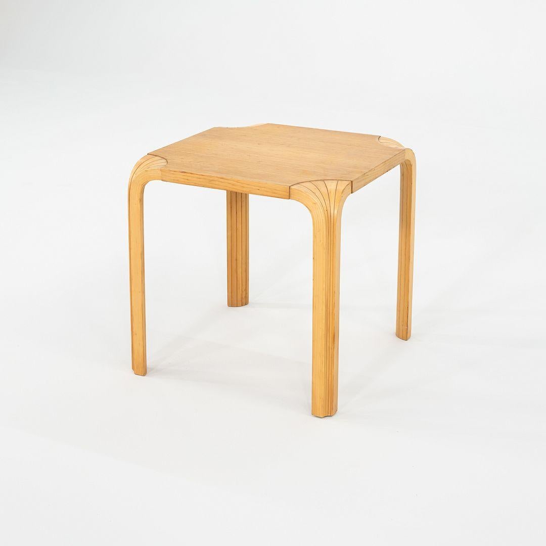 This is a Fan Leg Side Table, X601, originally designed by Aino and Alvar Aalto in 1954. This particular example was produced by Artek in Finland in the 1950s. The table features a round birch plywood top supported by the distinctive 