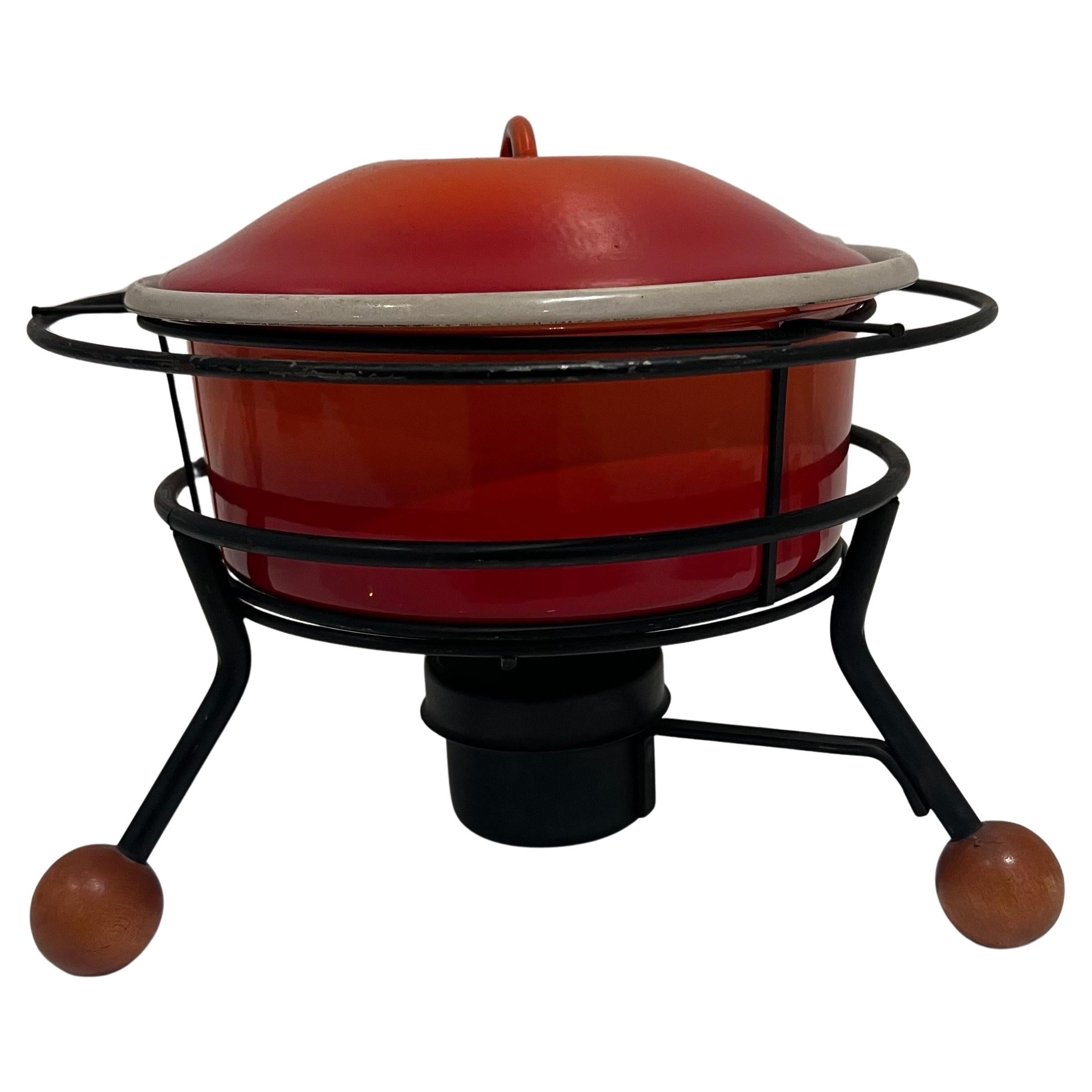 1950's rare vintage chafing dish , fondue pot food warmer in beautiful enameled orange with lid with black iron stand with wooden decorative feet, very nice condition almost no use a rare and hard to find piece that add to mid century , atomic age