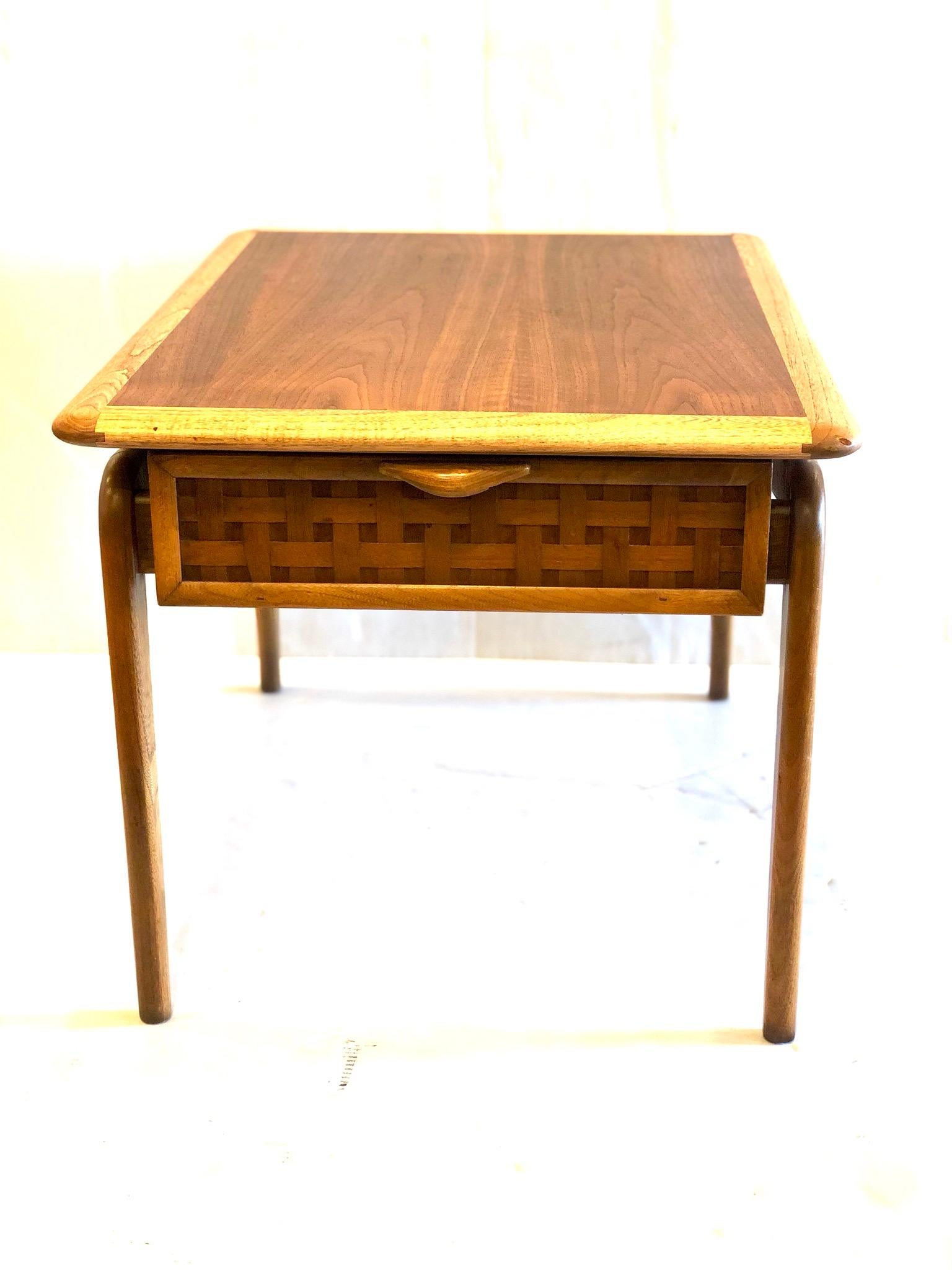 Beautiful craftsmanship on this 1950s, American modern walnut inlaid end table, with brass balls side accents, and beech wood combination, with drawer, the table is in great condition, totally refinished. Great between two club chairs or can be used