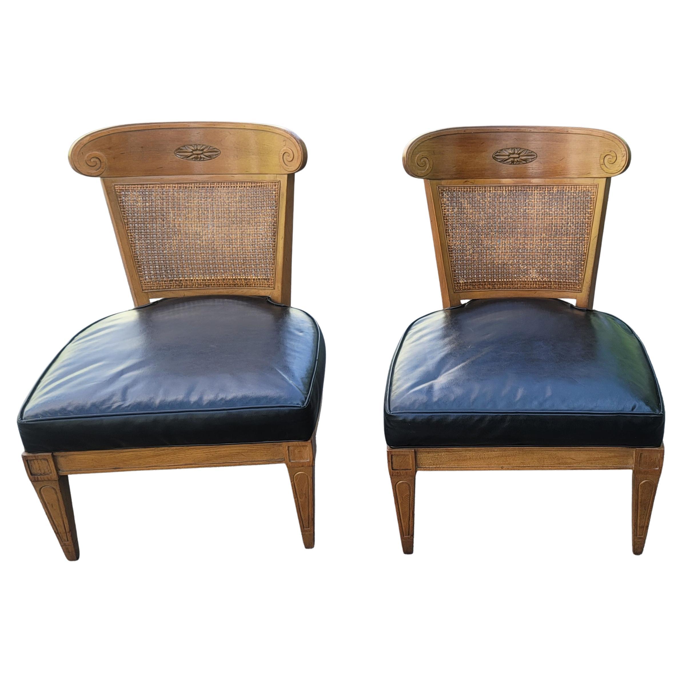 A gorgeous pair of vintage Mid-Century Modern slipper lounge chairs by American of Martinsville. They have a walnut frame with cane back and faux leather seat and are in good vintage condition. They are structurally sound, with wiggles or shimmy.