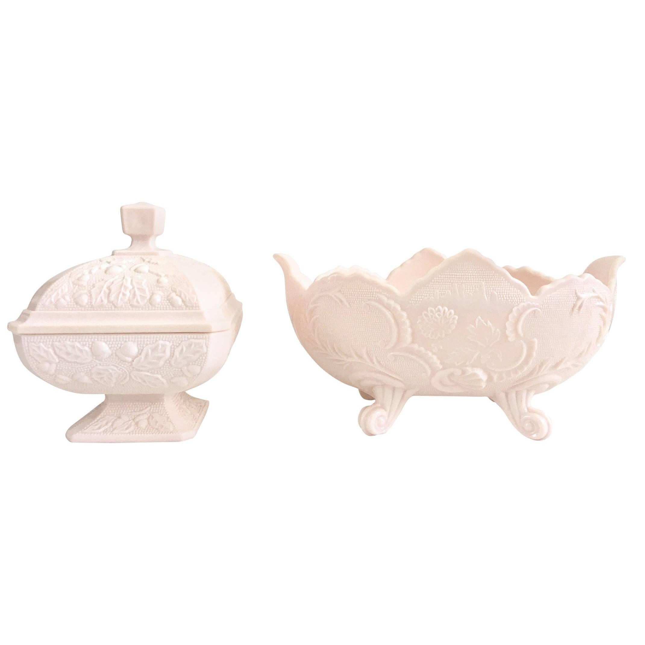 Midcentury set of two pieces American pink milk glass, lidded candy dish and footed oval bowl.
The lidded and footed candy dish features a raised hob nail, acorn and leaf pattern, the large oval footed bowl features a scroll and shell motif.
The