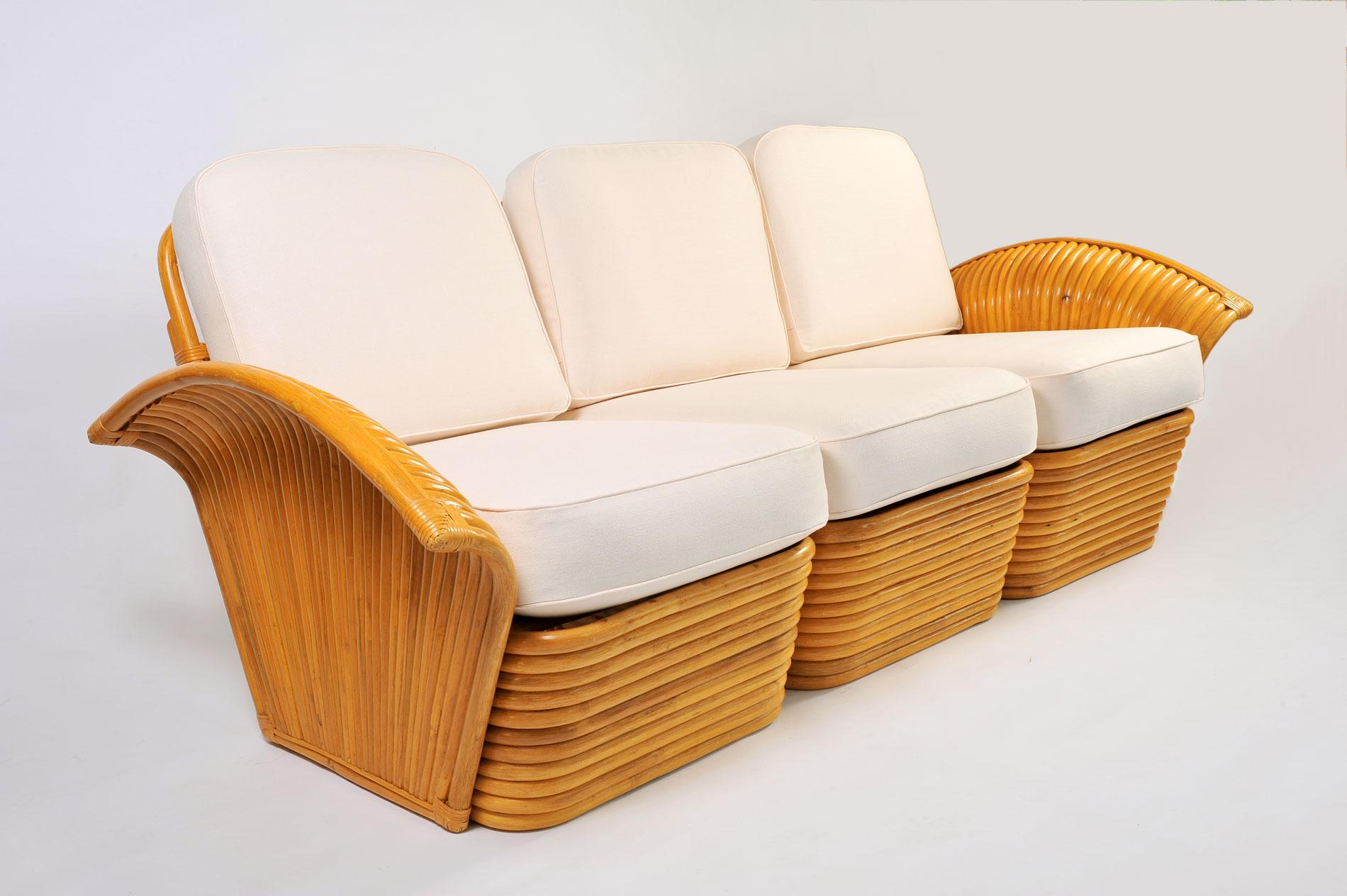 Very comfortable 1950s three-seat sectional sofa with curved stacked rattan base and decorative fan arms. Two armchairs in the same set are also available (see our separate entry, LU897212130421 ). Recently re-upholstered in thick white linen.