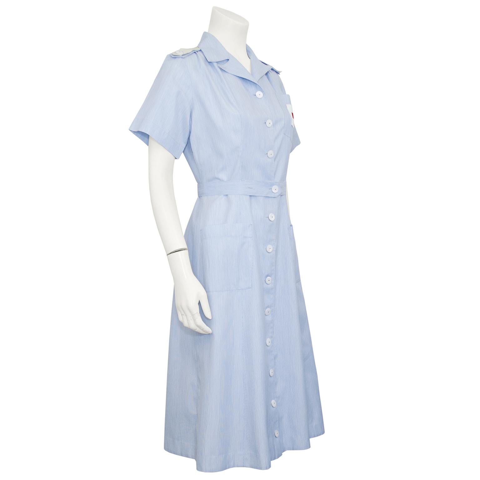 What a fun piece to add you collection of vintage. Authentic 1950's American Red Cross uniform that has all the style of the post WW2 era. Feminine and fitted with a hint of style. Subtle baby blue seersucker fabric with mother-of-pearl removable