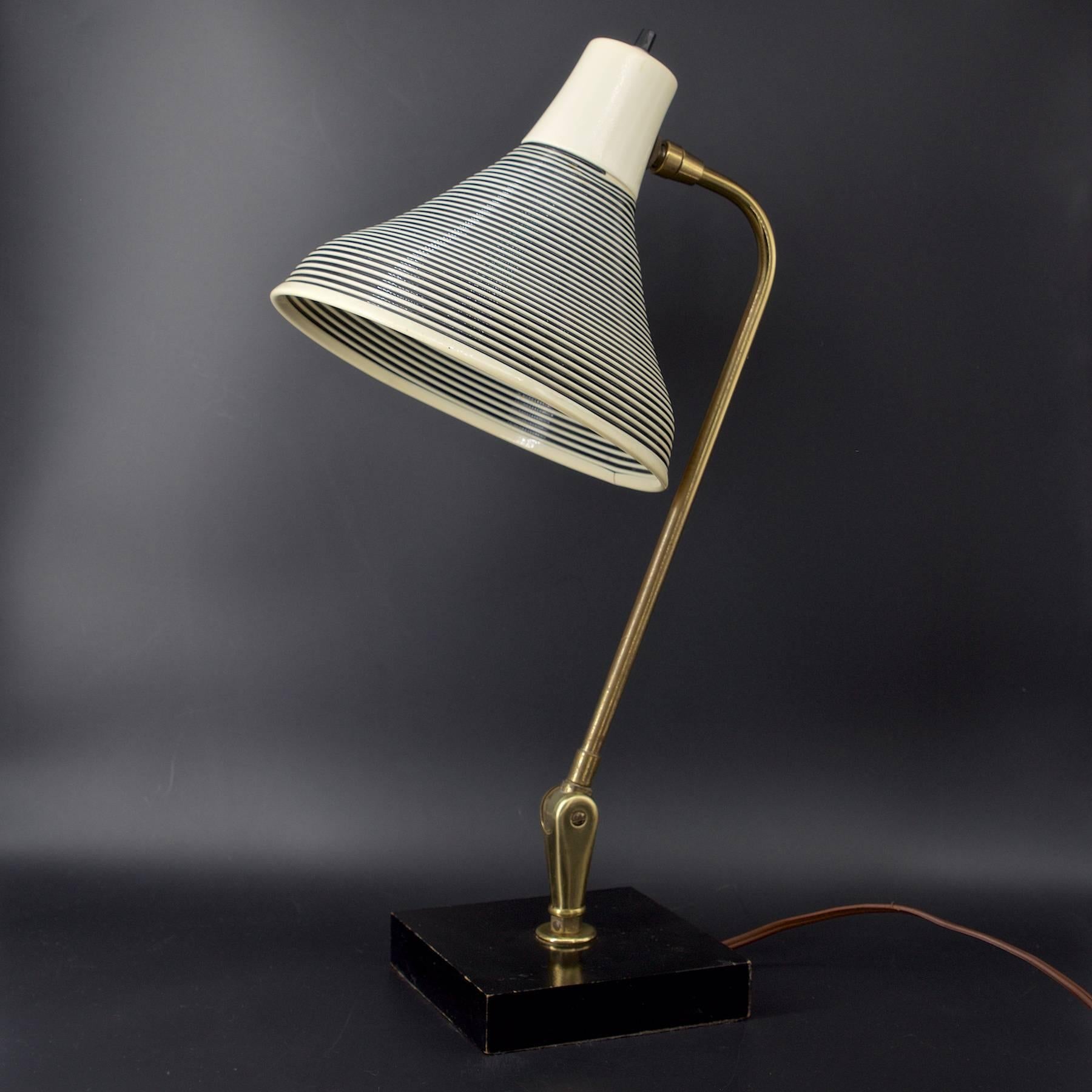 Wonderful wide flairing Rotoflex 1950s adjustable desk lamp on black lacquered wooden base. No markers markings found. Fully functional.