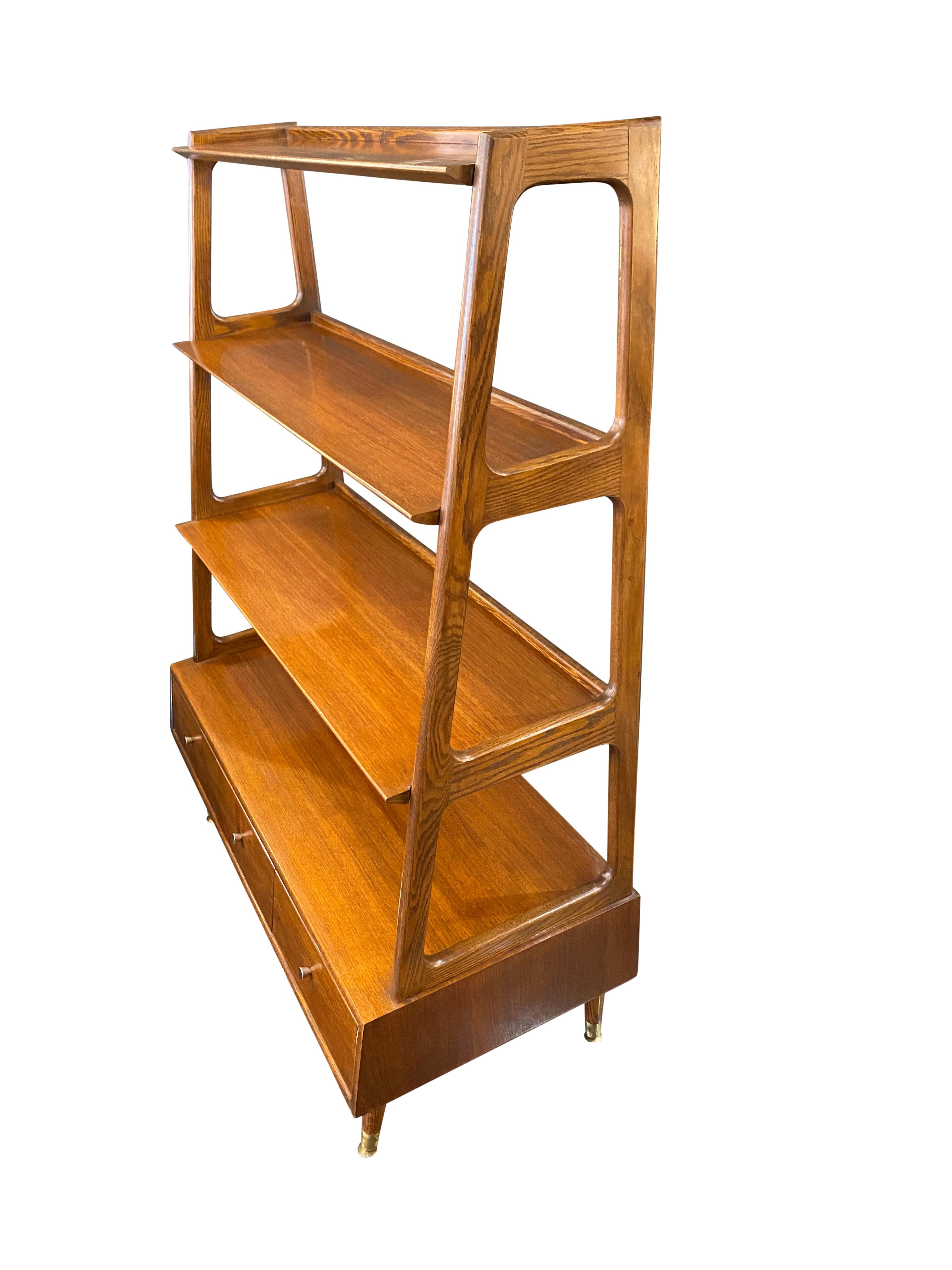 Walnut etagere room divider consisting of 4 shelves and 3 drawers produced by Saginaw - USA.


 