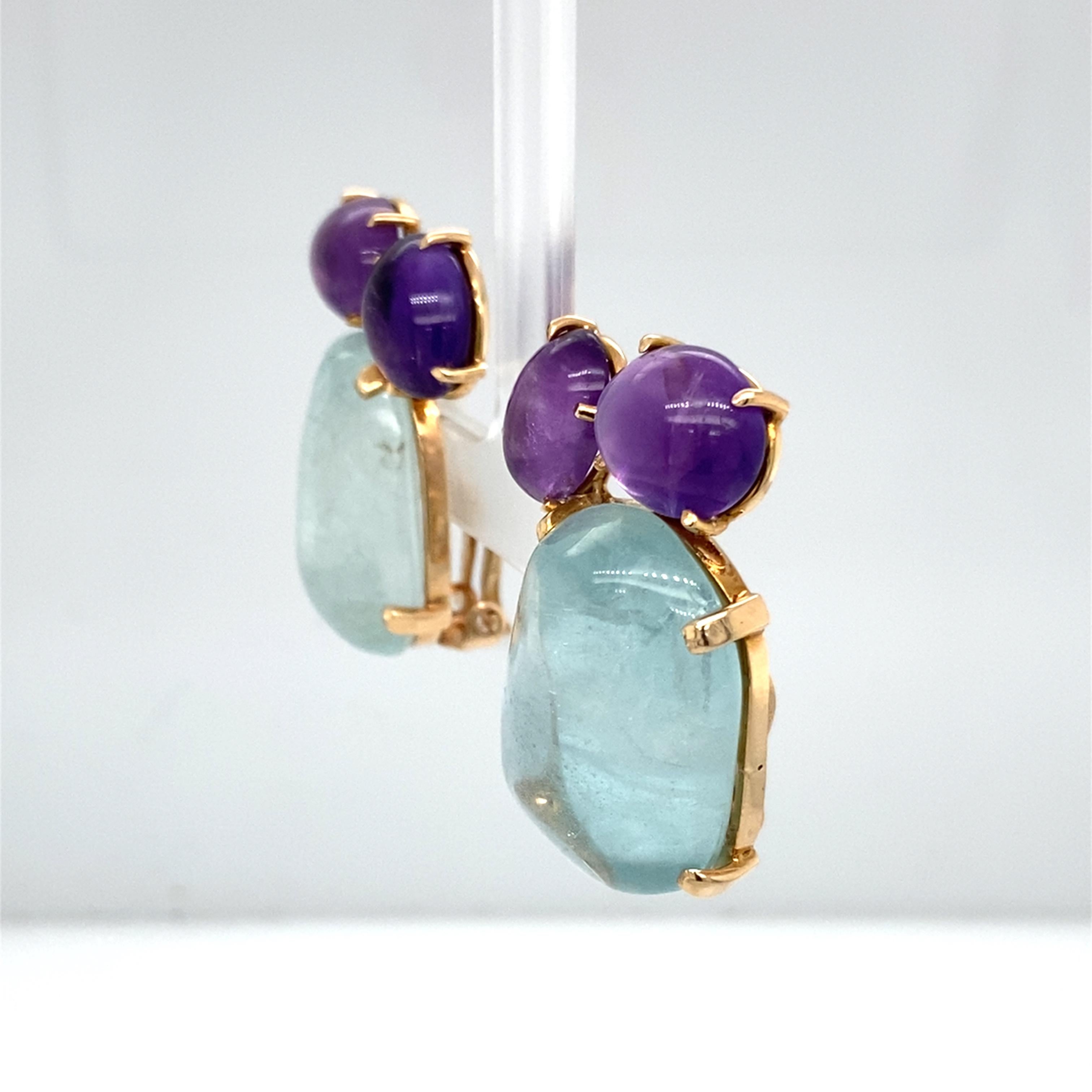 Item Features:
Cabochon Amethyst & Aquamarine
14 Karat Yellow Gold
29.8 grams
1.25 inches length X .75 inches width

Item Details:
Features beautiful Cabochon Amethyst and Aquamarine in 14 karat yellow. Each earring is designed with 2 oval cabochon