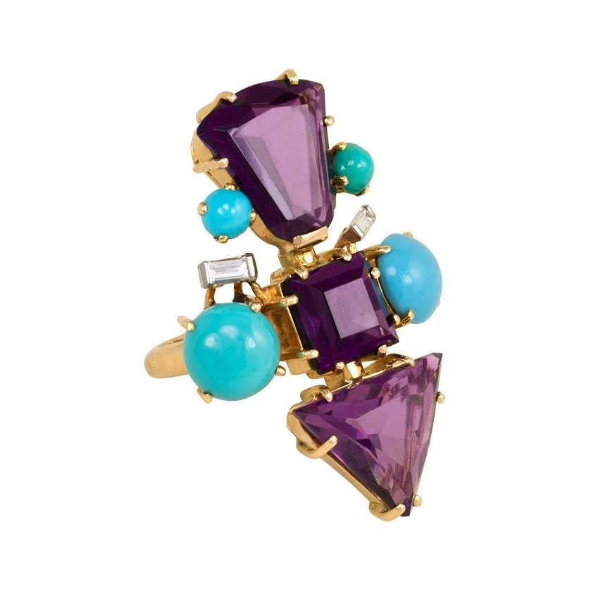 A mid-century amethyst, turquoise, and diamond cocktail ring of geometric design comprising three amethysts of various cuts, flanked by four turquoise cabochons and two diamond baguettes, in 18k gold.  France.  Face-up vertical measurement