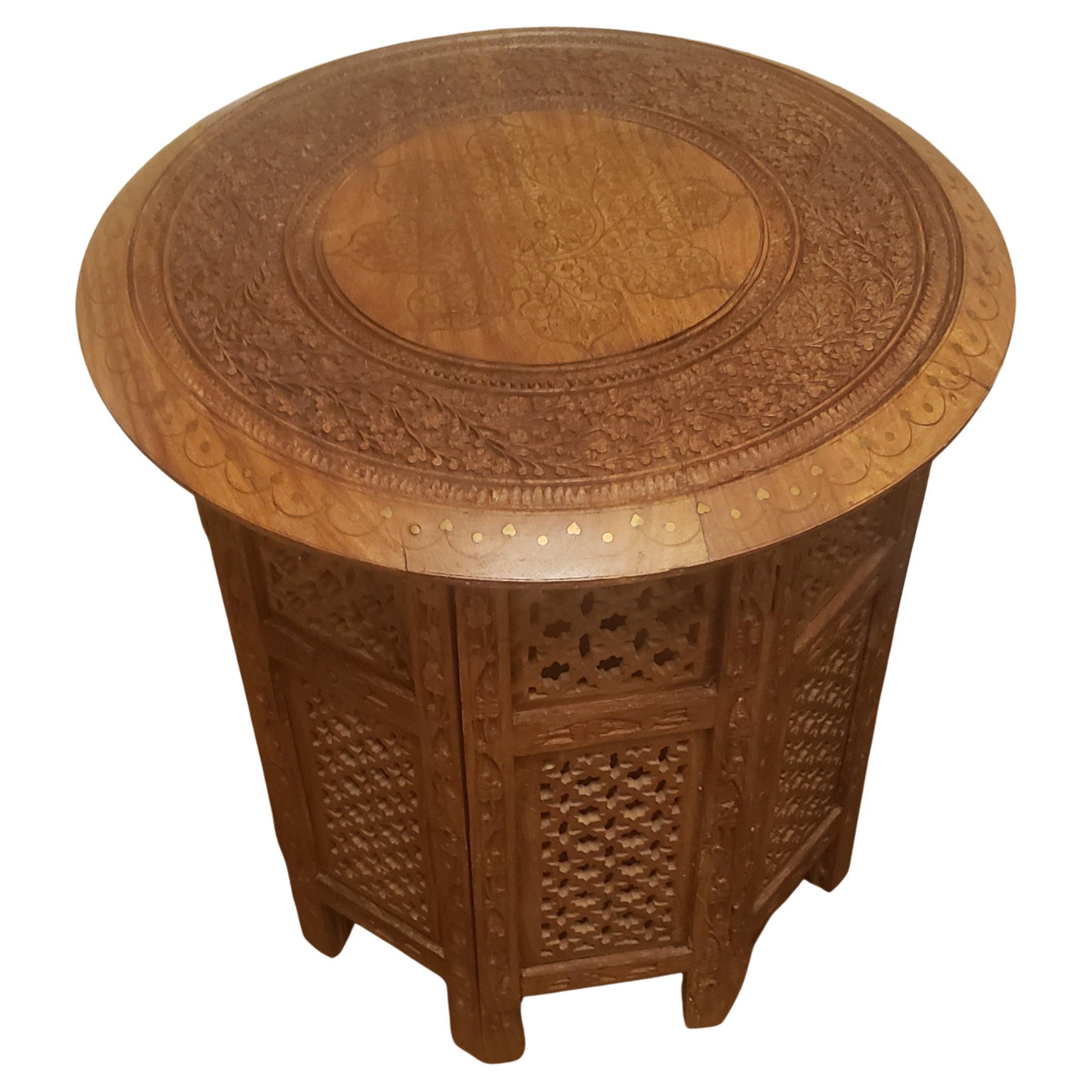 1950s Anglo-Indian Octagonal finely hand carved teak side table with intricate brass inlays in the center top and around the top. Table is collapsible, making it a great space saver. Table measures 18