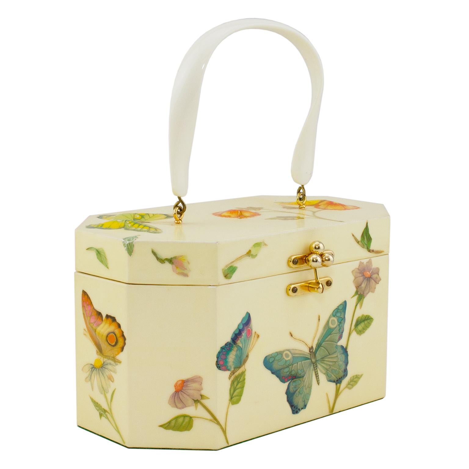 The most lovely little 1950s handbag by Annie Laurie Palm Beach. Hard beige plastic with beautiful, 3D flowers and butterflies done in a form of decoupage. Curved white plastic top handle and gold tone metal clasp and hardware. Periwinkle blue