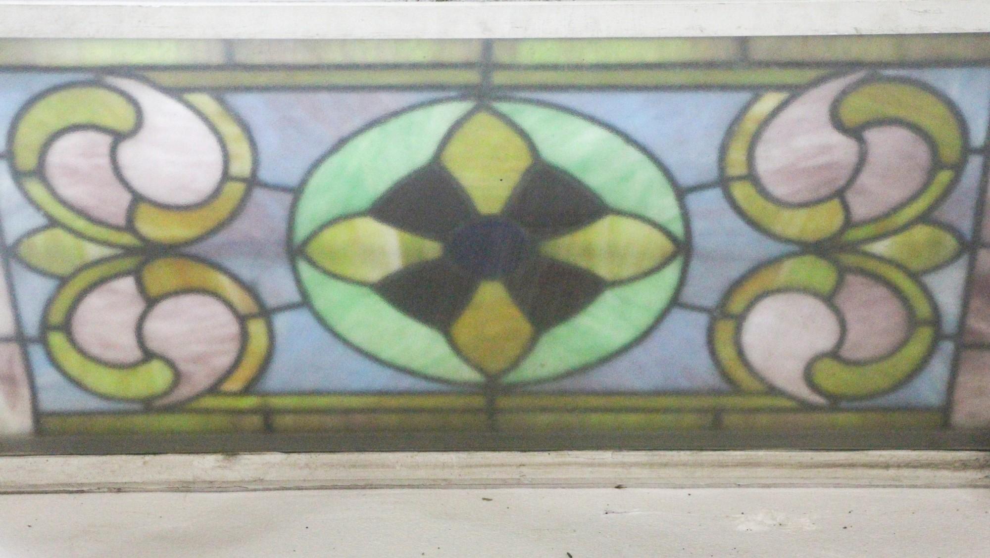 Original 1950s antique stained glass with vivid blue and green colors. The glass is mounted in a newer aluminum clad encasement window. Minor cracks. This can be seen at our 400 Gilligan St location in Scranton, PA.