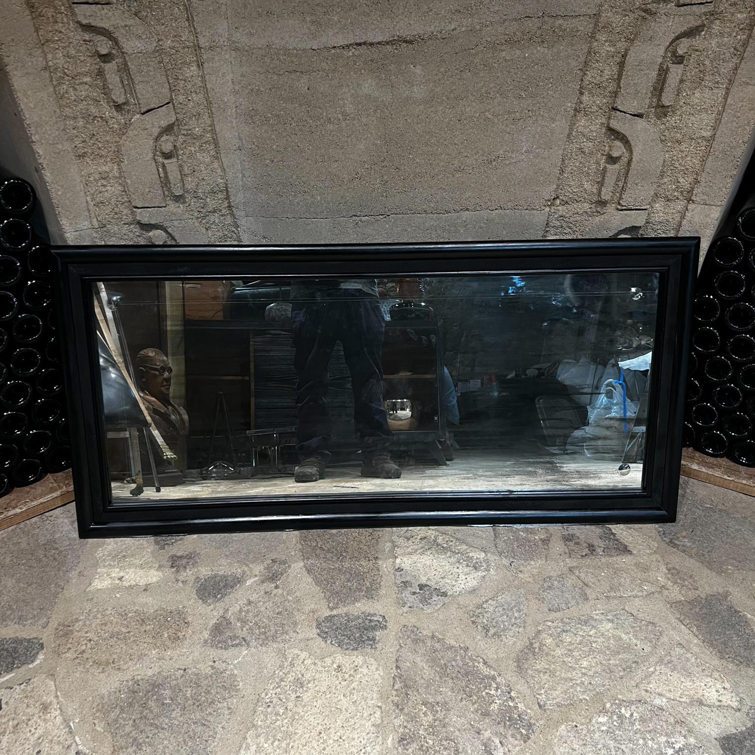 1950s Antique Wall Mirror Mexico City.
features satin black concave glass subtle lines 
fabulous vintage patina 
52.5 x 25 x 1.5 thick
Concave decorative patterns around the corners subtle lines horizontally and vertically.
No stamp from the