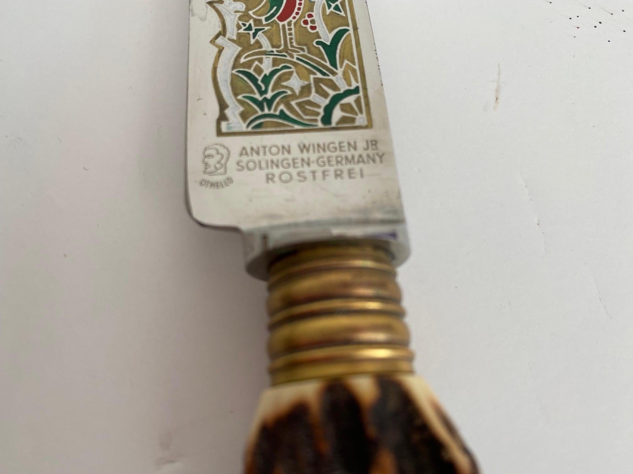 This is a vintage/antique German Anton Wingen Jr. Solingen cutlery and carving set. This unique meat carving set is made of stainless steel and stag antler handles. The stainless steel is etched and hand-painted with a bird and crop scenes.