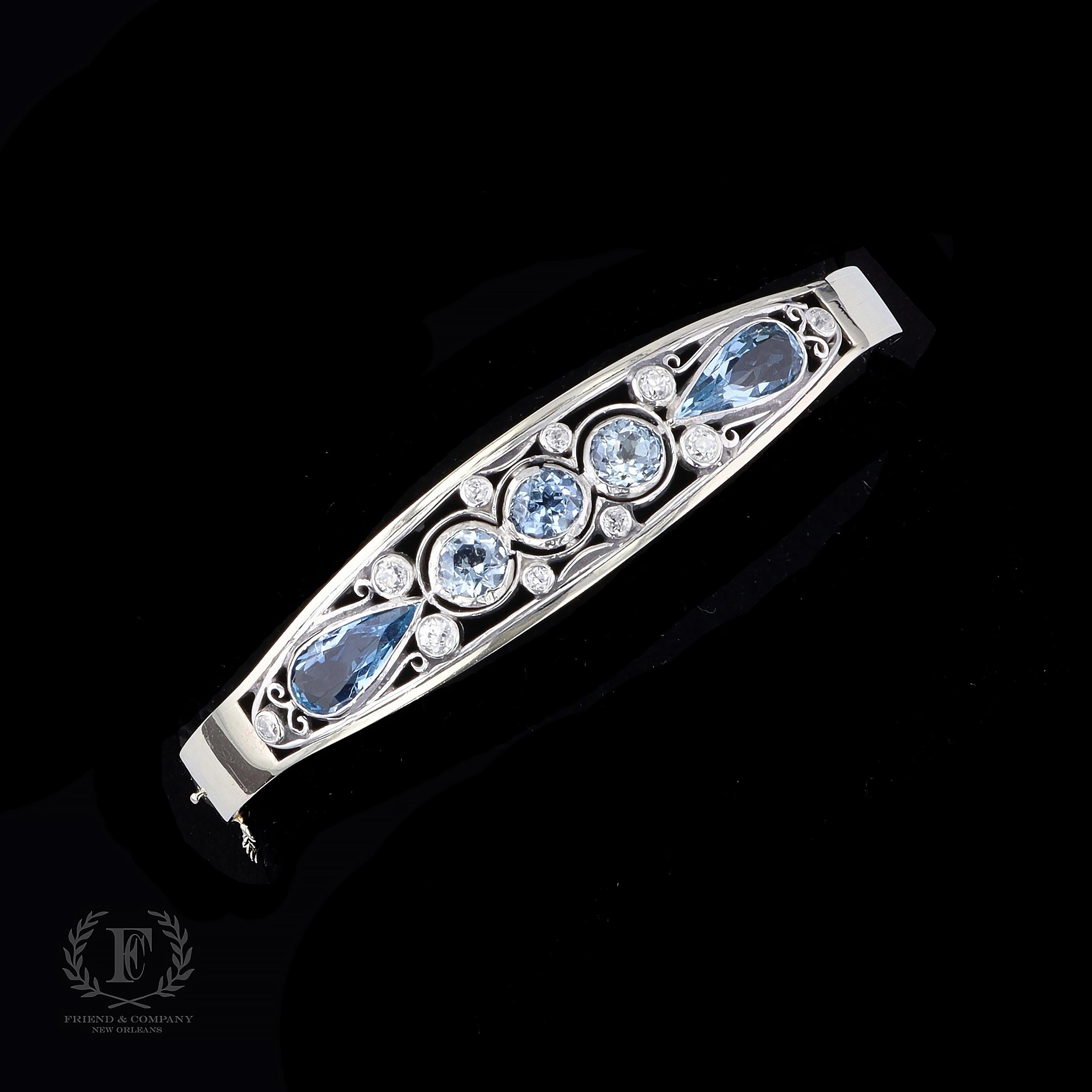 A 1950s treasure. This bangle bracelet is set with pear and round cut aquamarines and old mine cut diamonds that weigh approximately 7.00 carats and 0.40 carats respectively. The bangle measures 13 millimeters in width at the widest base and will