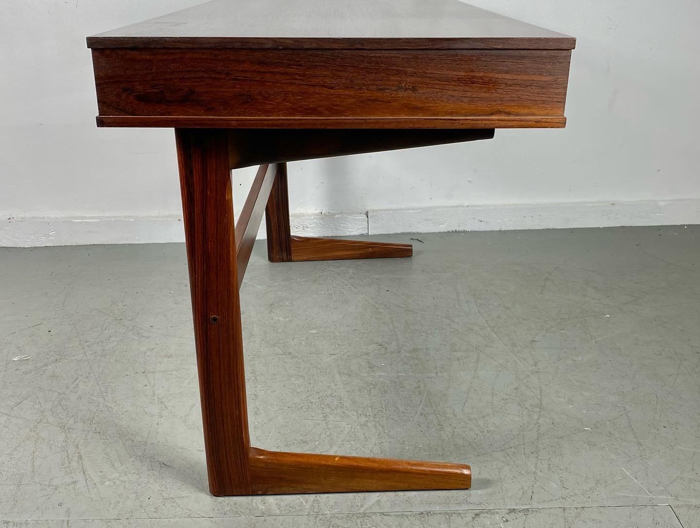GEORG PETERSENS Danish rosewood Cantilever desk. Modern Minimalist form 3 drawer cabinet supported by cantilever legs with back stretcher. Made in Denmark.-Richly grained rosewood,,- Wonderful original condition,, Hand delivery avail to New York