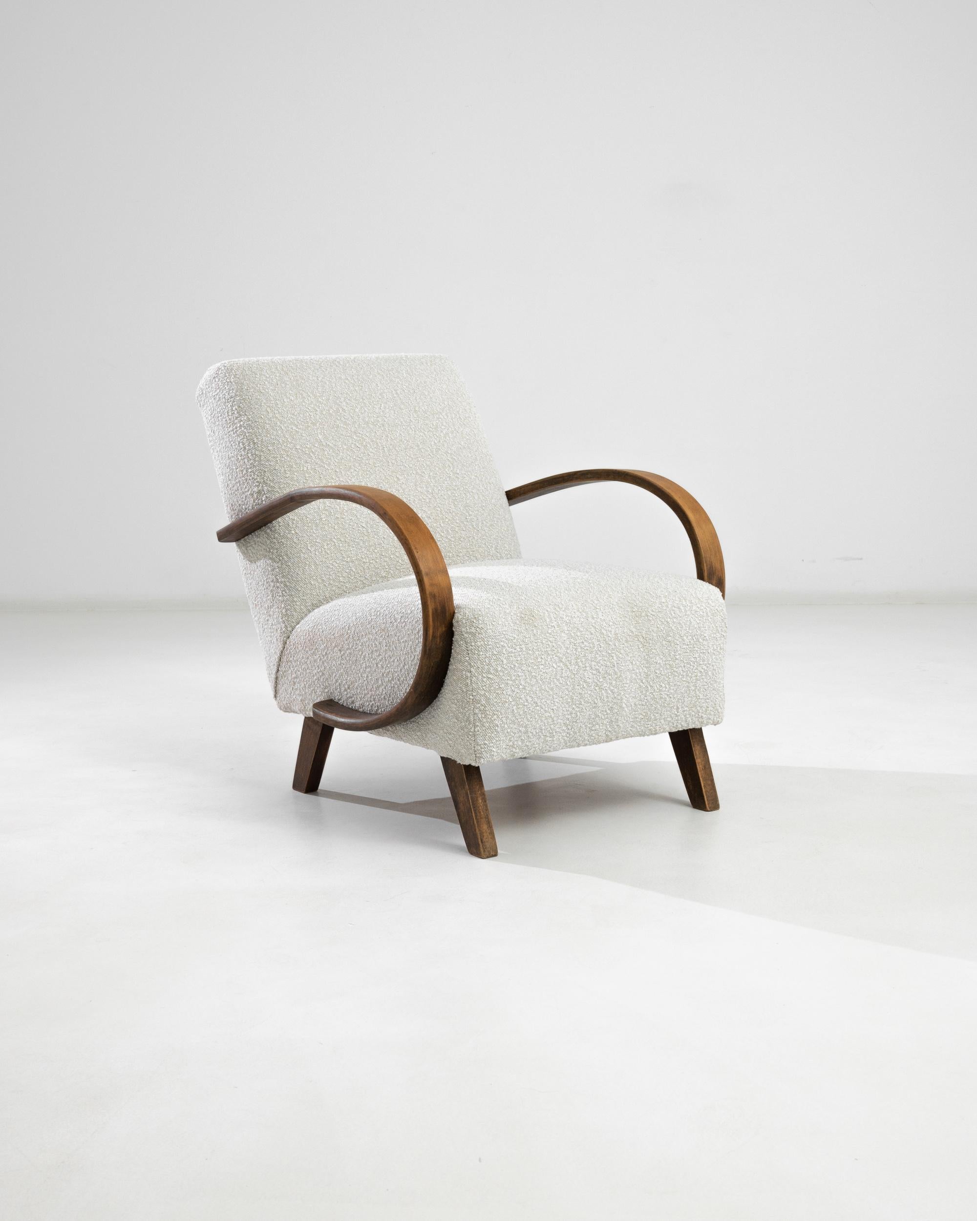 An armchair by Czech furniture designer J. Halabala. Made in the 1950s, these bentwood designs was produced in Central European furniture factories throughout the 20th century. The eye-catching Silhouette and comfortable shape has had an enduring