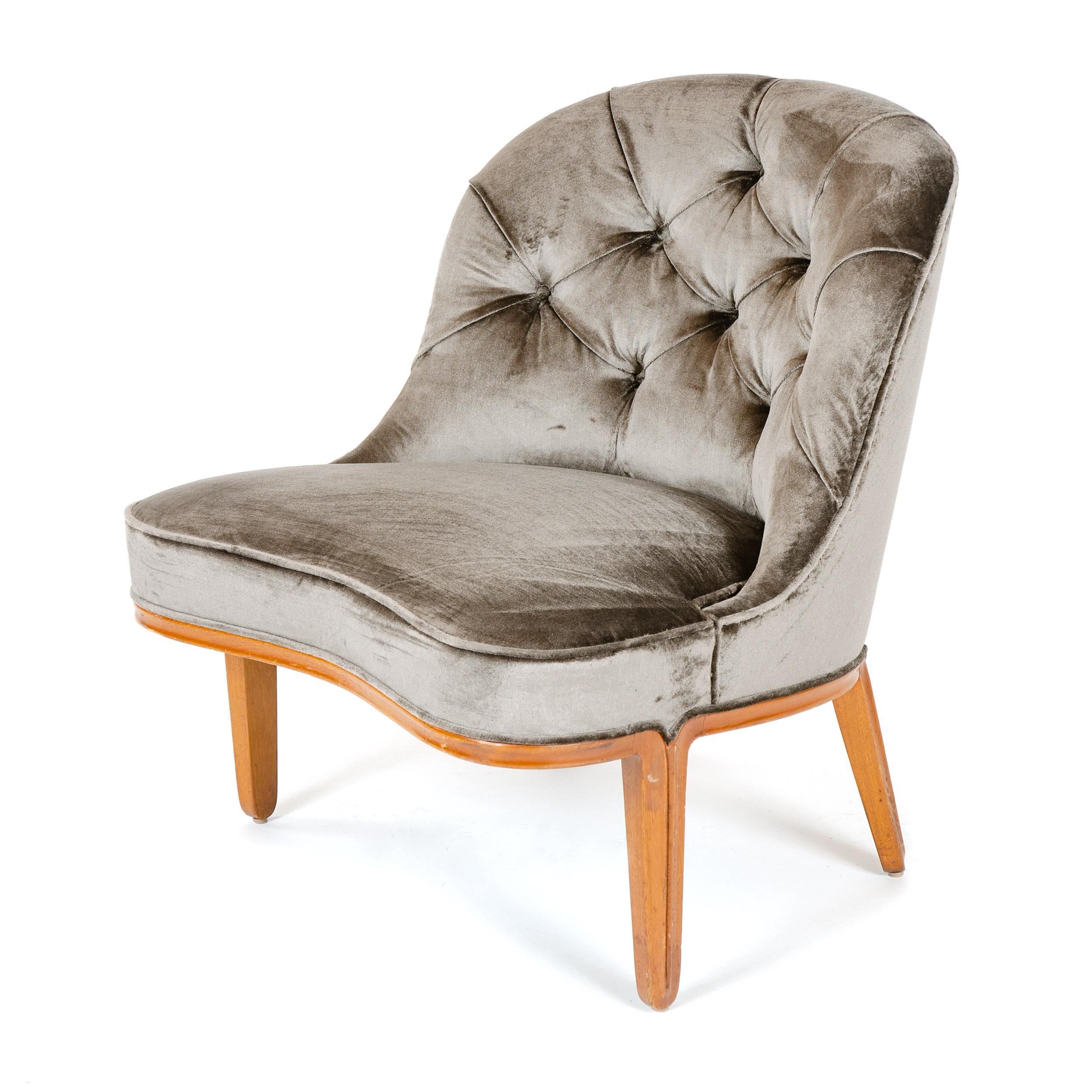 An armless slipper chair from the Janus collection with button tufted upholstery and beautifully carved integral walnut base. Model 5775.