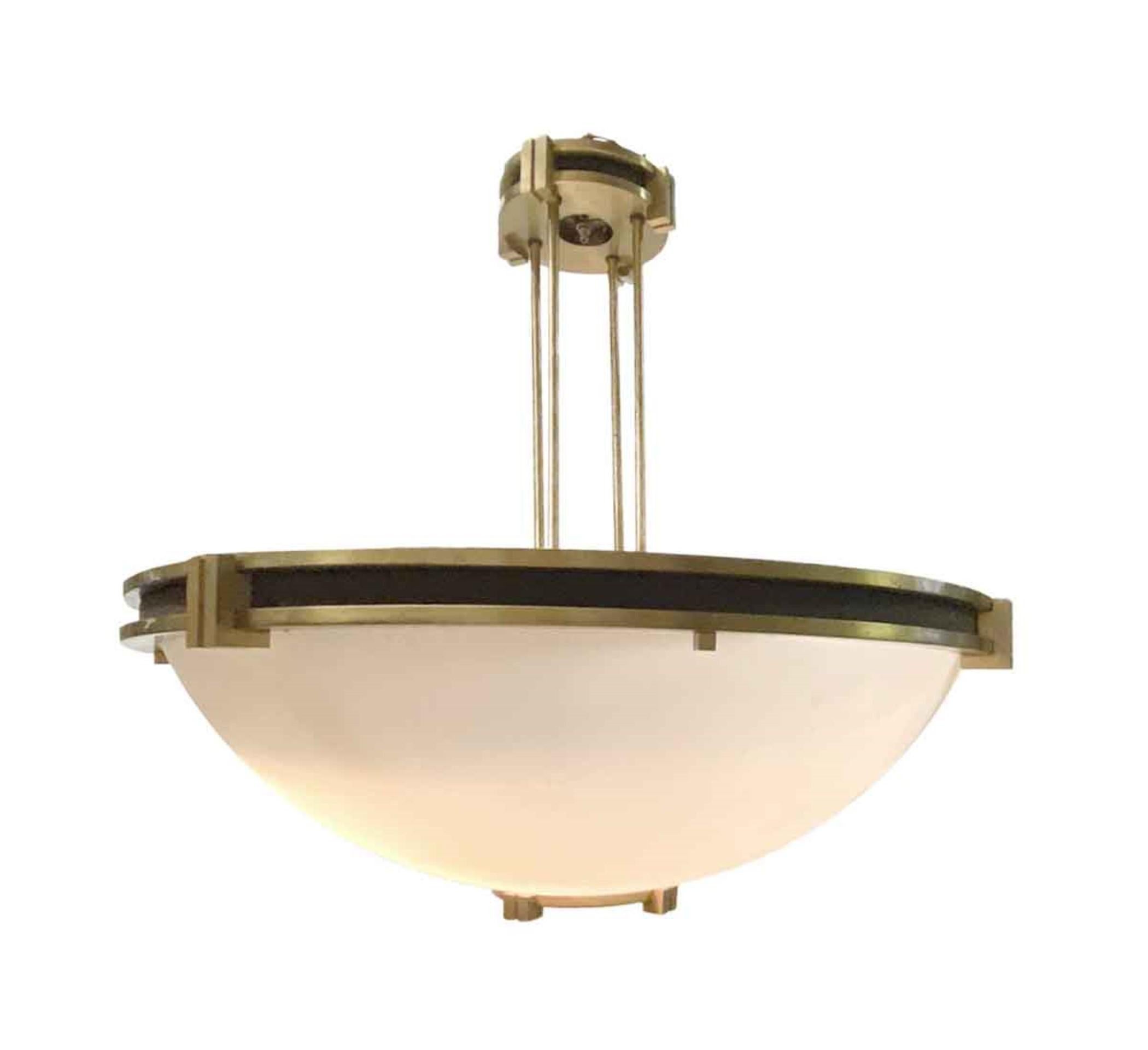 1950s Art Deco pendant dish light blending a geometric Art Deco influence as well. Features details in brass and black finishes topped off with an acrylic shade. From a bank in Manhattan. Takes eight standard light bulbs. This can be seen at our 400