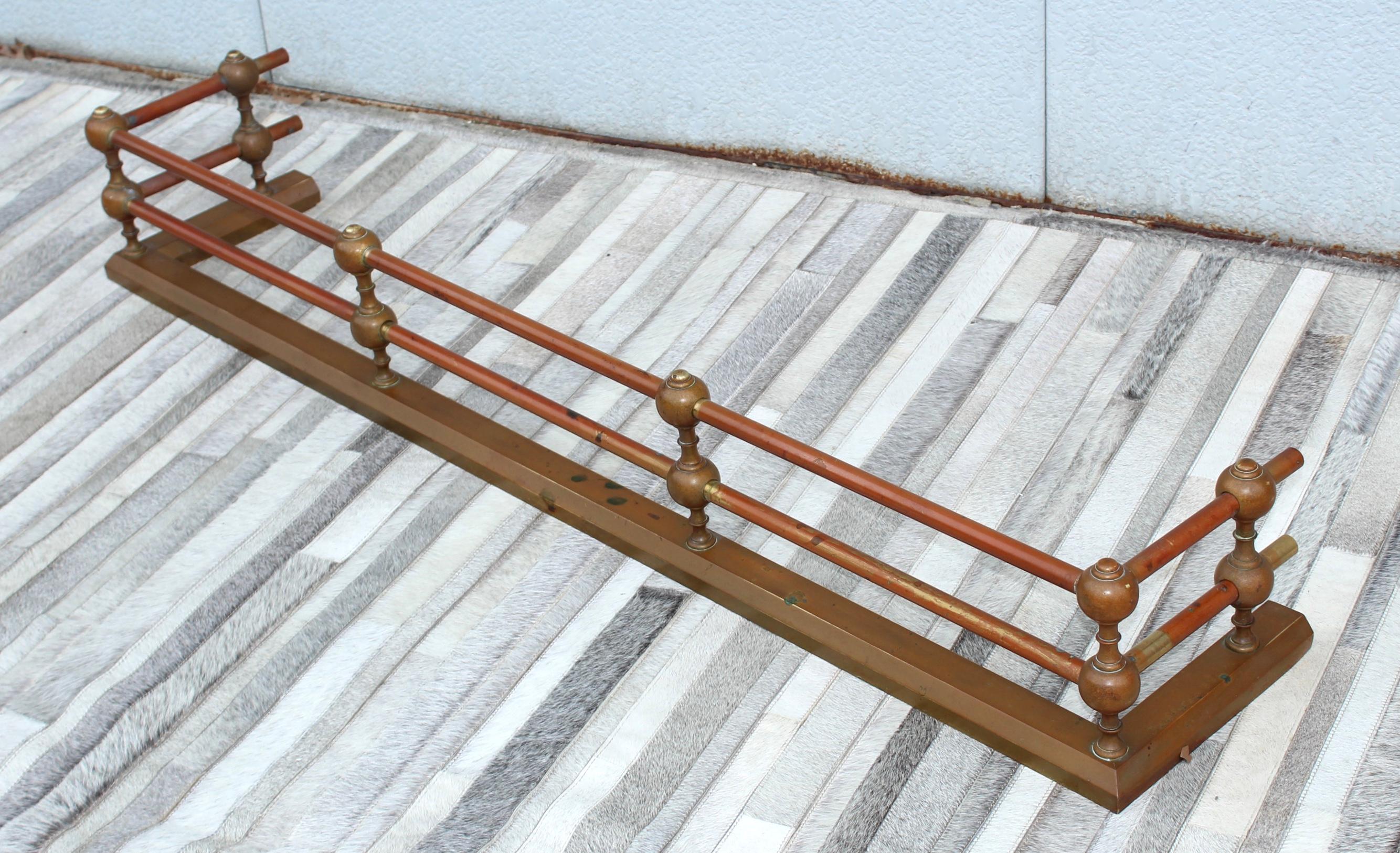1950's solid brass Art-Deco style fireplace fender, in vintage original condition with some wear and patina to the brass.