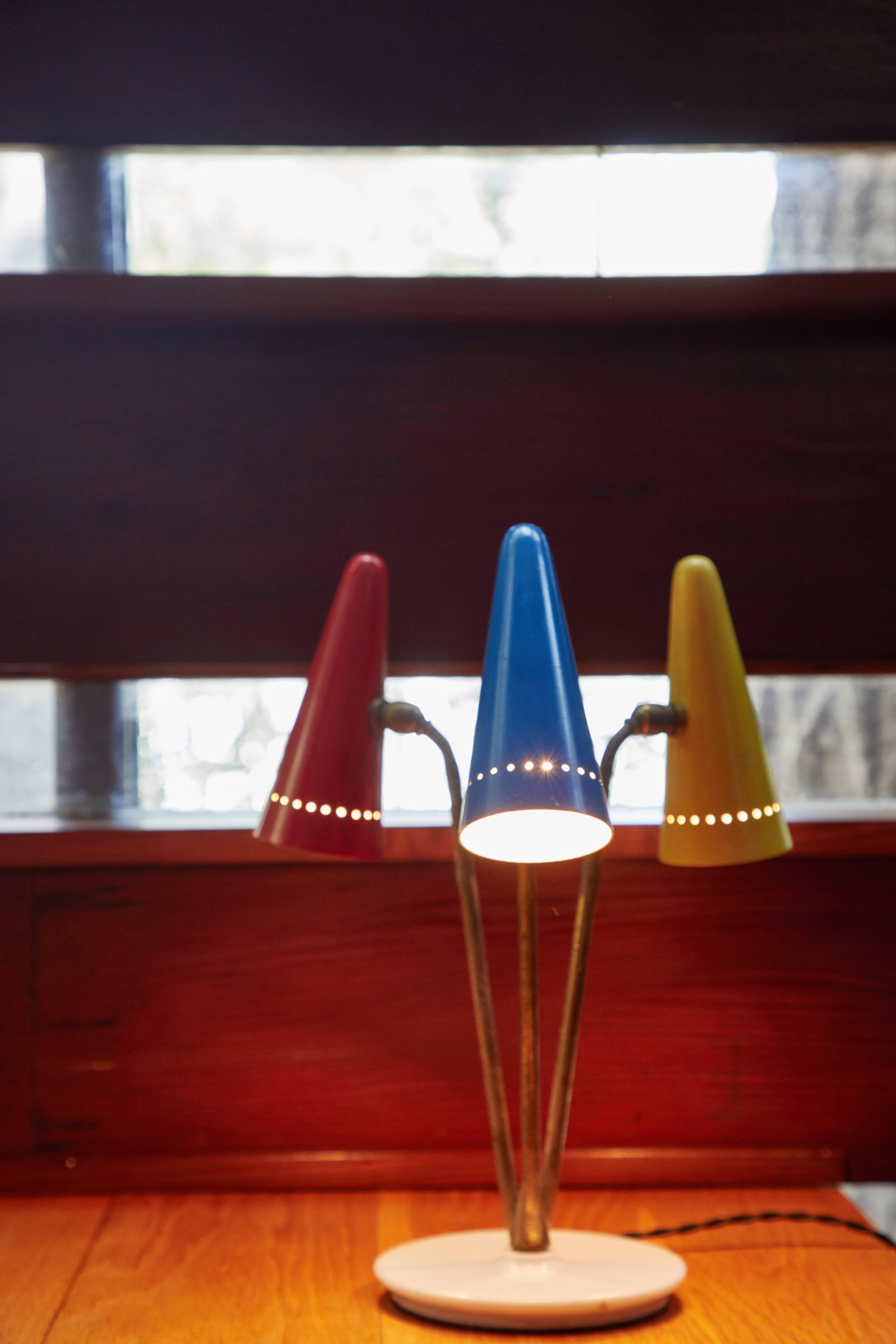 Rare 1950s Arteluce Tricolore table lamp. This extremely rare and iconic design executed in painted metal, brass and marble with original color in very good vintage condition. The individual cone shades rotate independently for a variety of lighting