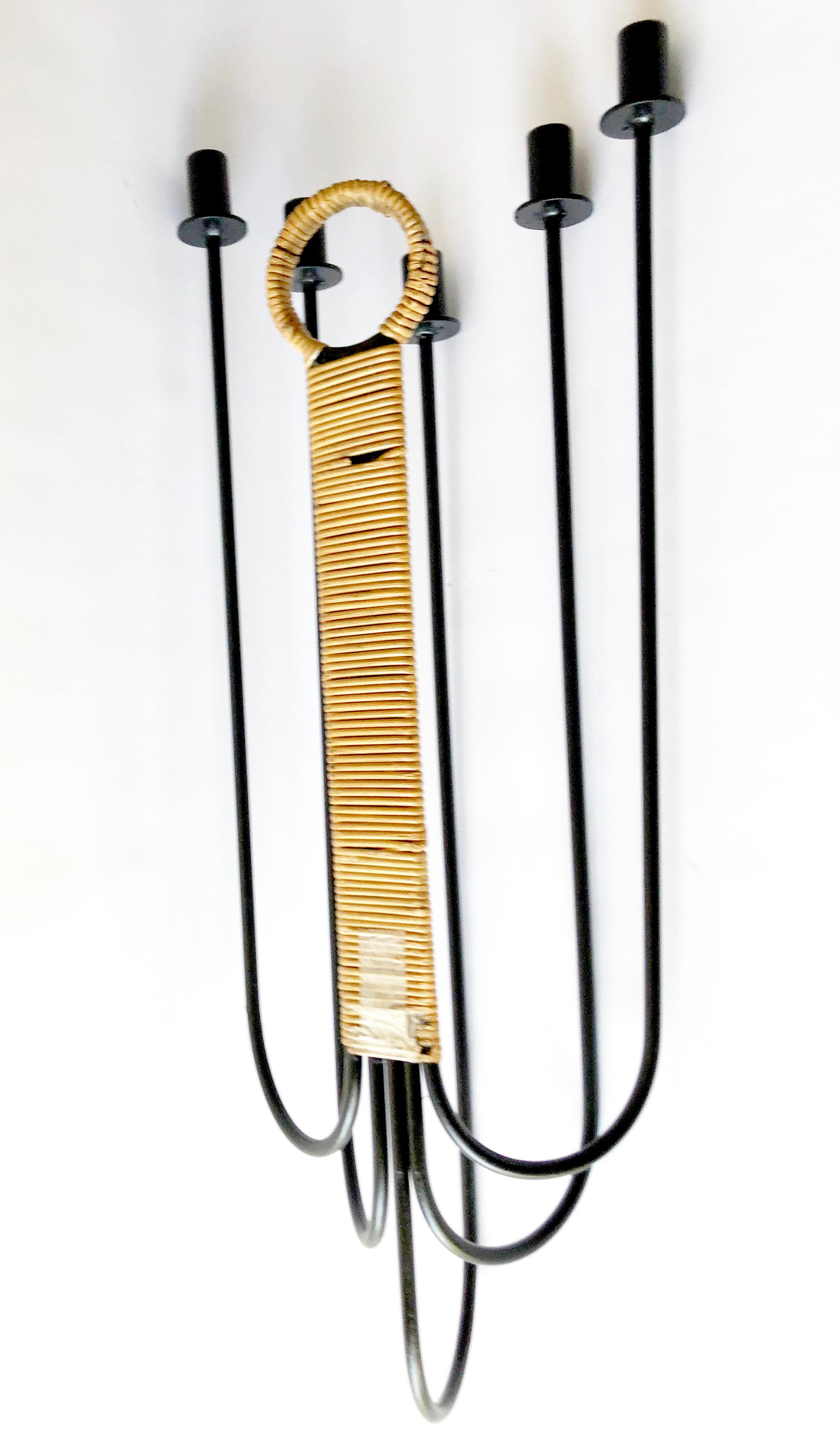 Arthur Umanoff for Raymor caned wrought iron wall candelabrum, circa 1950s. Piece measures 30
