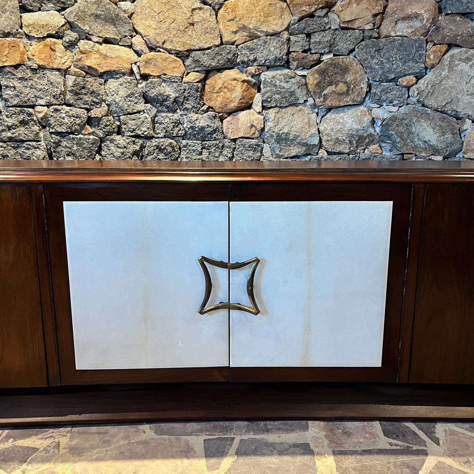 For your consideration, a  Credenza made in Mexico City circa the 1950s.
Unmarked. Attribution Arturo Pani
Mahogany wood. Two tone presentation.
Center doors are covered in off-white leather.
Magnificent brass pulls & sabots with vintage