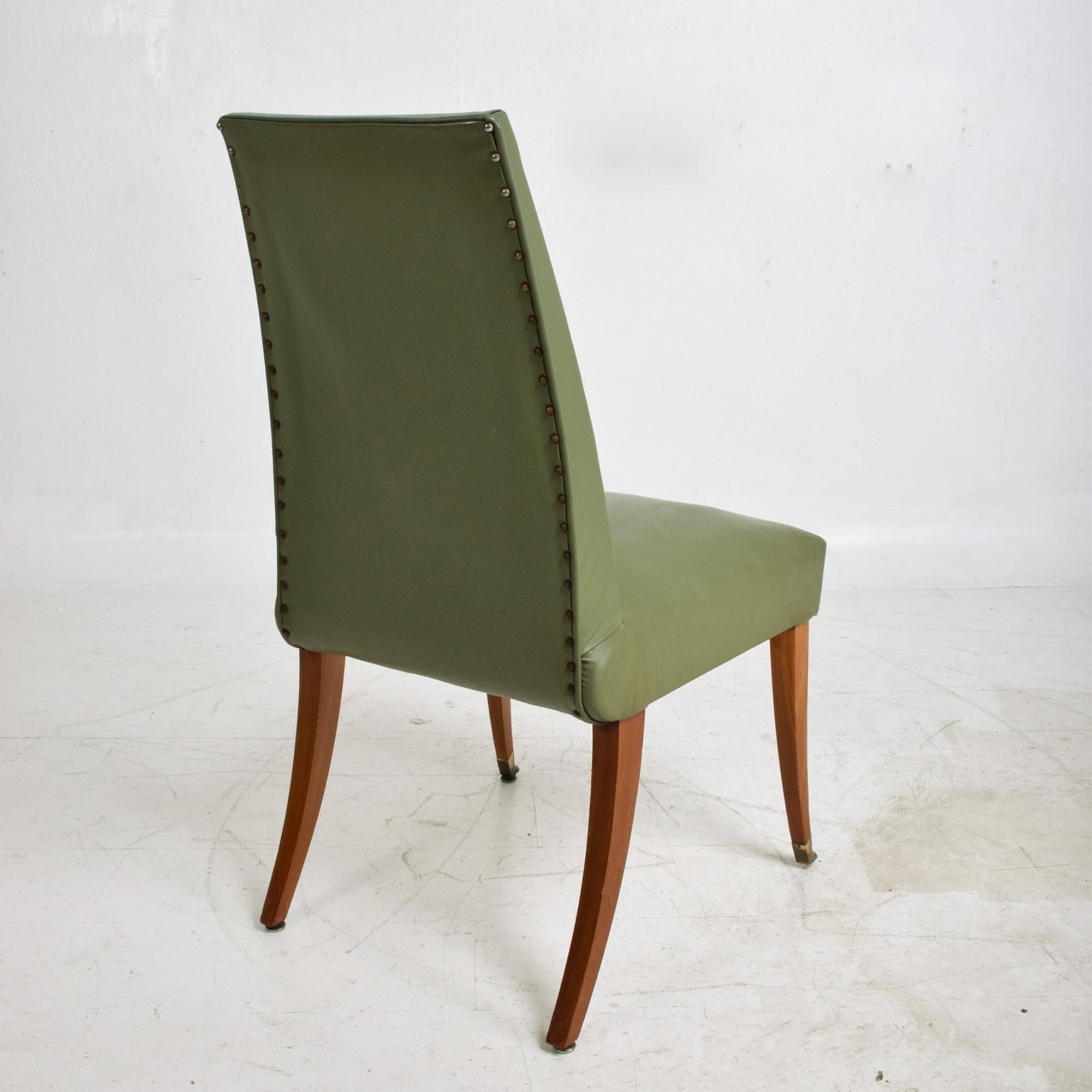 Sophisticated Arturo Pani Dining Chairs Set of 8 in Faux Green Leather
flared mahogany wood with solid brass leg tips
Unmarked attributed to Arturo Pani 1950s
37.38 tall x 25 D x 19.5 W, Seat 18 tall
Original vintage preowned condition. 
New