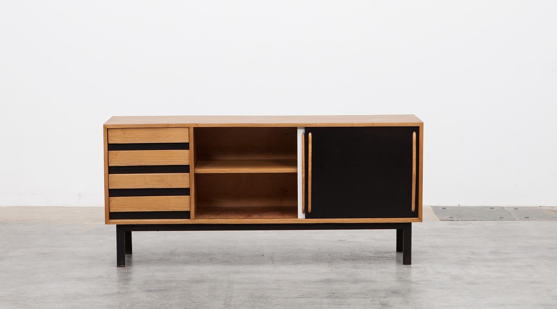 Sideboard in ash and laminate by Charlotte Perriand, France, 1958.

Beautiful and really rare Charlotte Perriand sideboard edited by Steph Simon. The corpus, drawers and grips are in ash veneer, the sliding doors in black and white are laminate. The