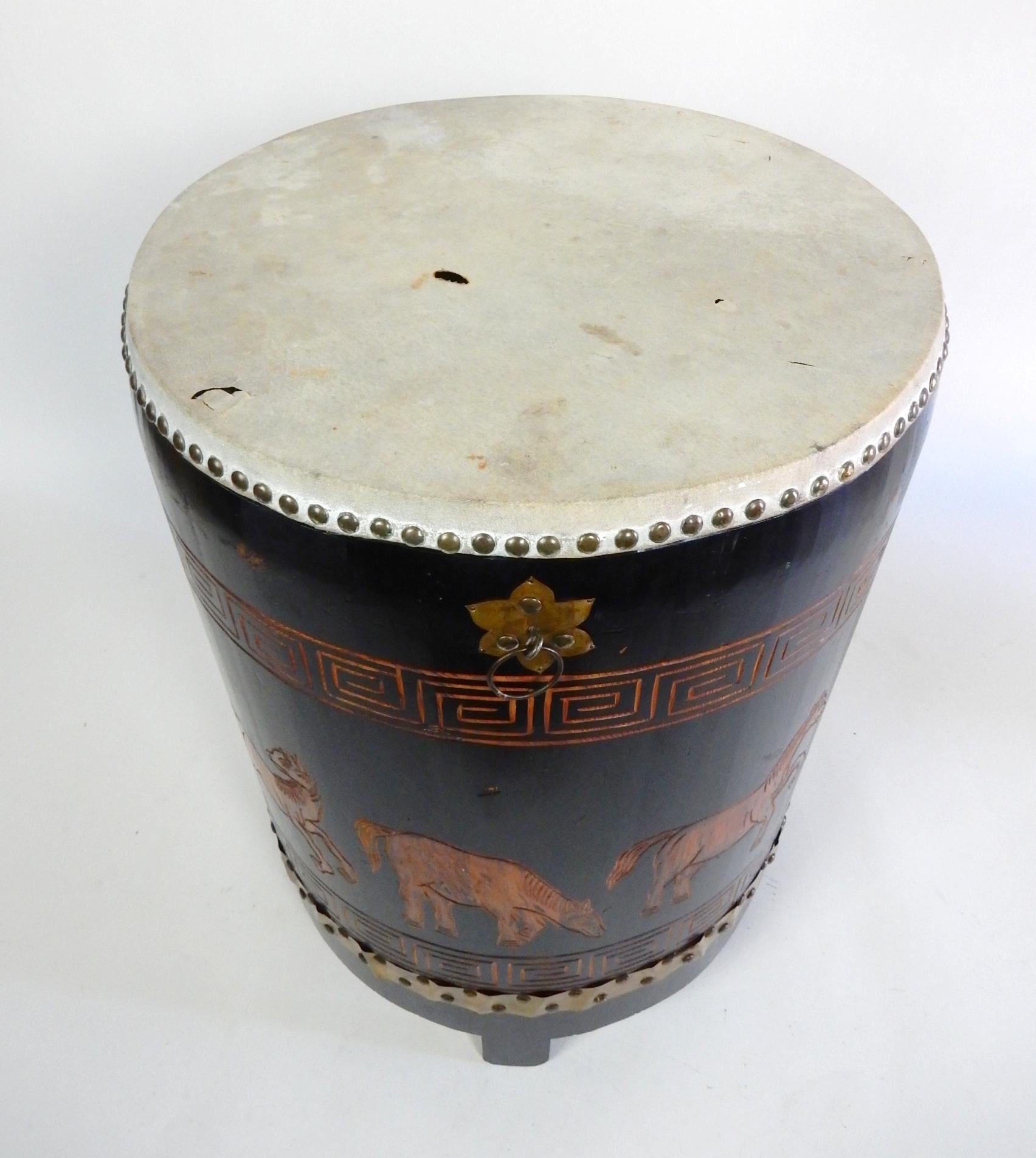 This would make a unique side table or stand.
1950s Asian Tang horse drum with a skin top.
Hand caved & painted details all the way around with 
3 brass ring handles as well as nailhead banded strap. 
Stands 24in tall x 18in across.
Shipped via