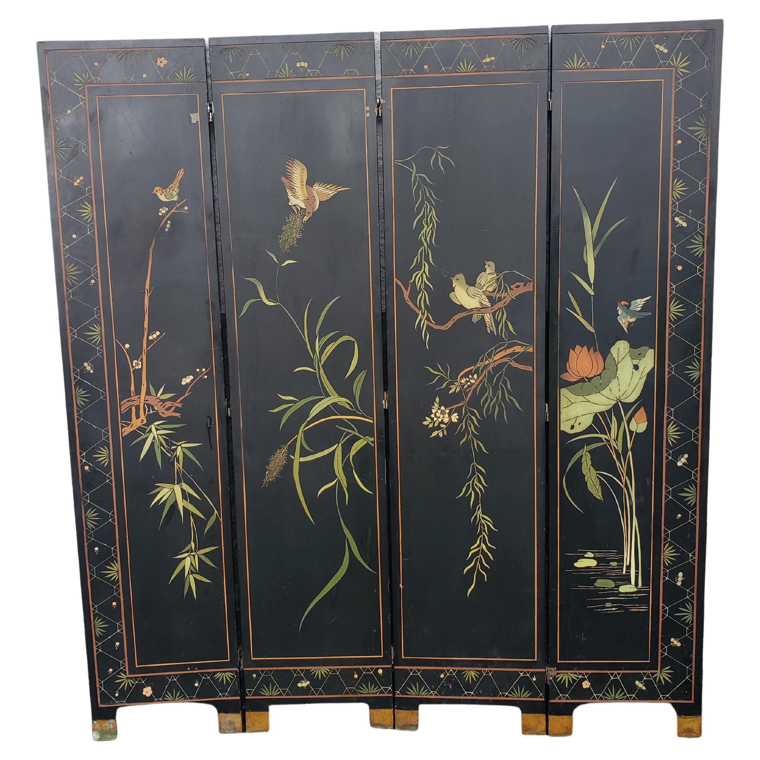 This vintage wood 4 panel, black lacquered Asian room divider is beautifully carved and painted on both sides. Each side displaying a different scene, one side for with birds and flowers, the other side for Asian Taiga forest scene. Brass capped