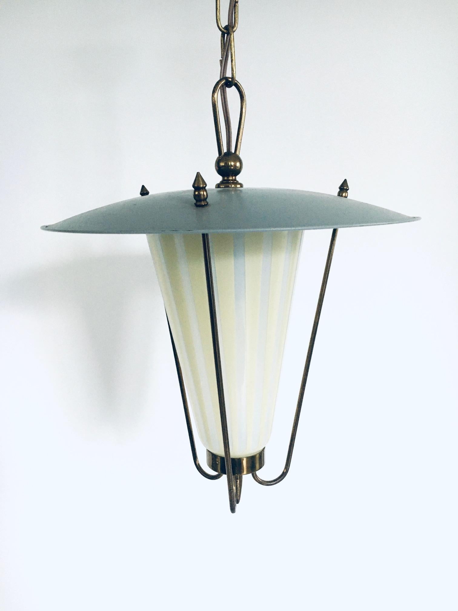 Vintage 1950's Midcentury Modern Atomic Age Design pendant Lantern Hanging Lamp. Made in France, 1950's. Metal and brass with 2 color glass shade. In very good condition. Measures 39cm x 32cm x 32cm.