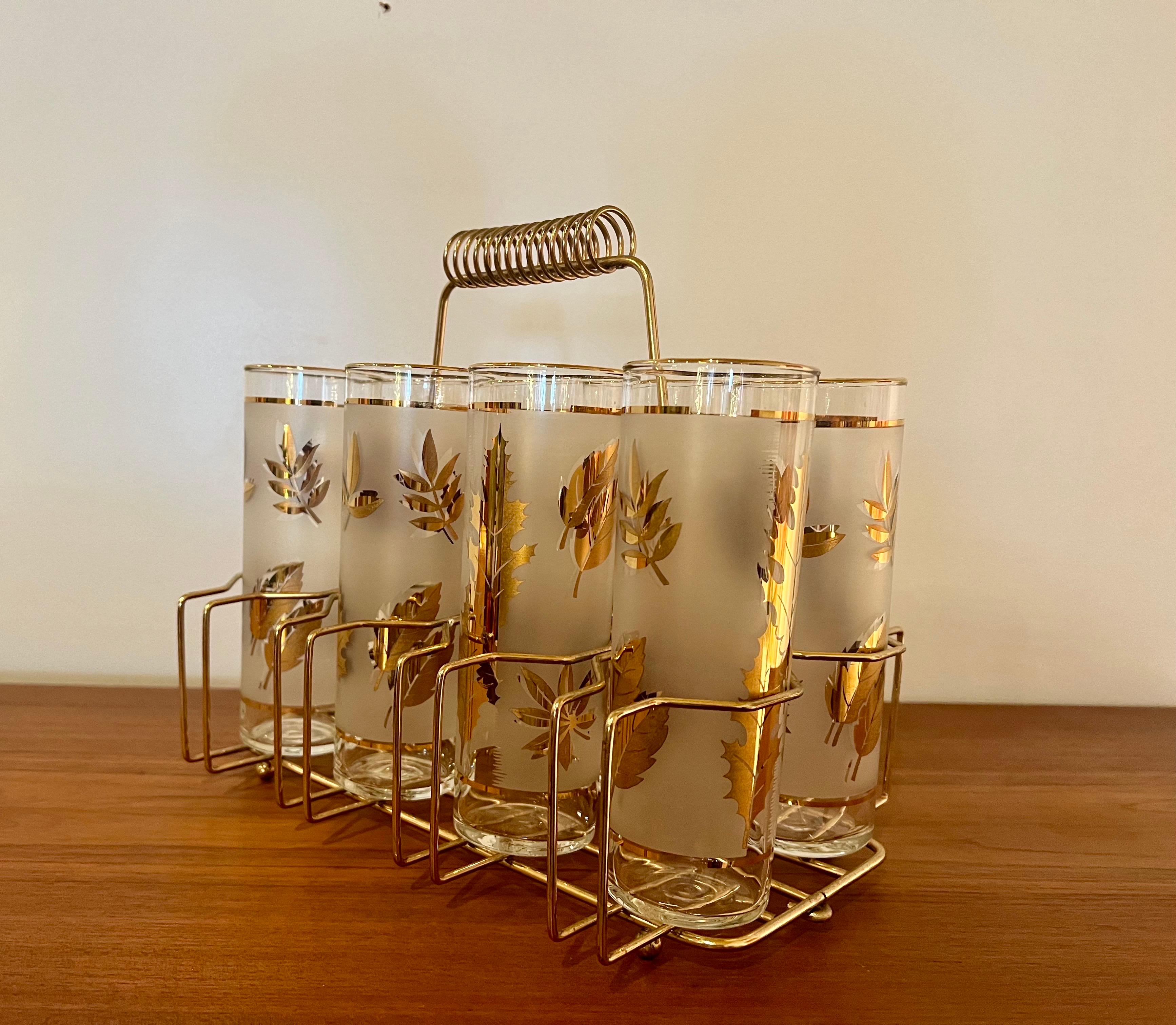 A rare to find set of 8 highball glasses by Libbey Golden , circa 1950's great condition perfect for the season , with caddy 