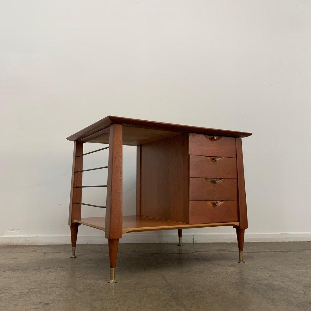 Measures: W30 D24 H24.5

Atomic Side Tables made of mahogany wood. Contains two drawers; thin top drawer, and a tall drawer (illusion of multiple). Features inset sculpt and brass hardware. Item has been refinished and is fully functional. Two