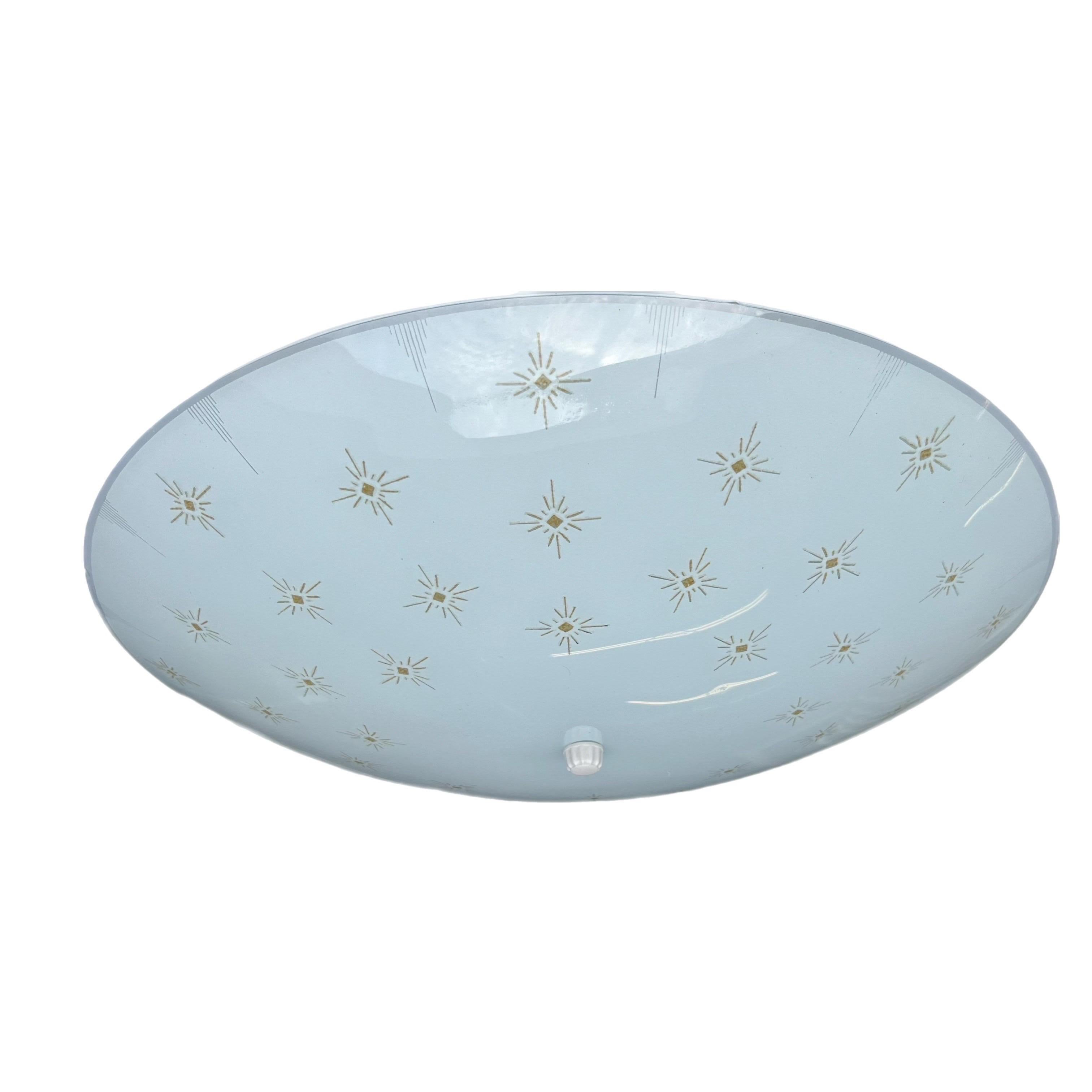 Atomic retro 1950-60's flying saucer starburst ceiling light made of glass and brass with a double bulb fixture.