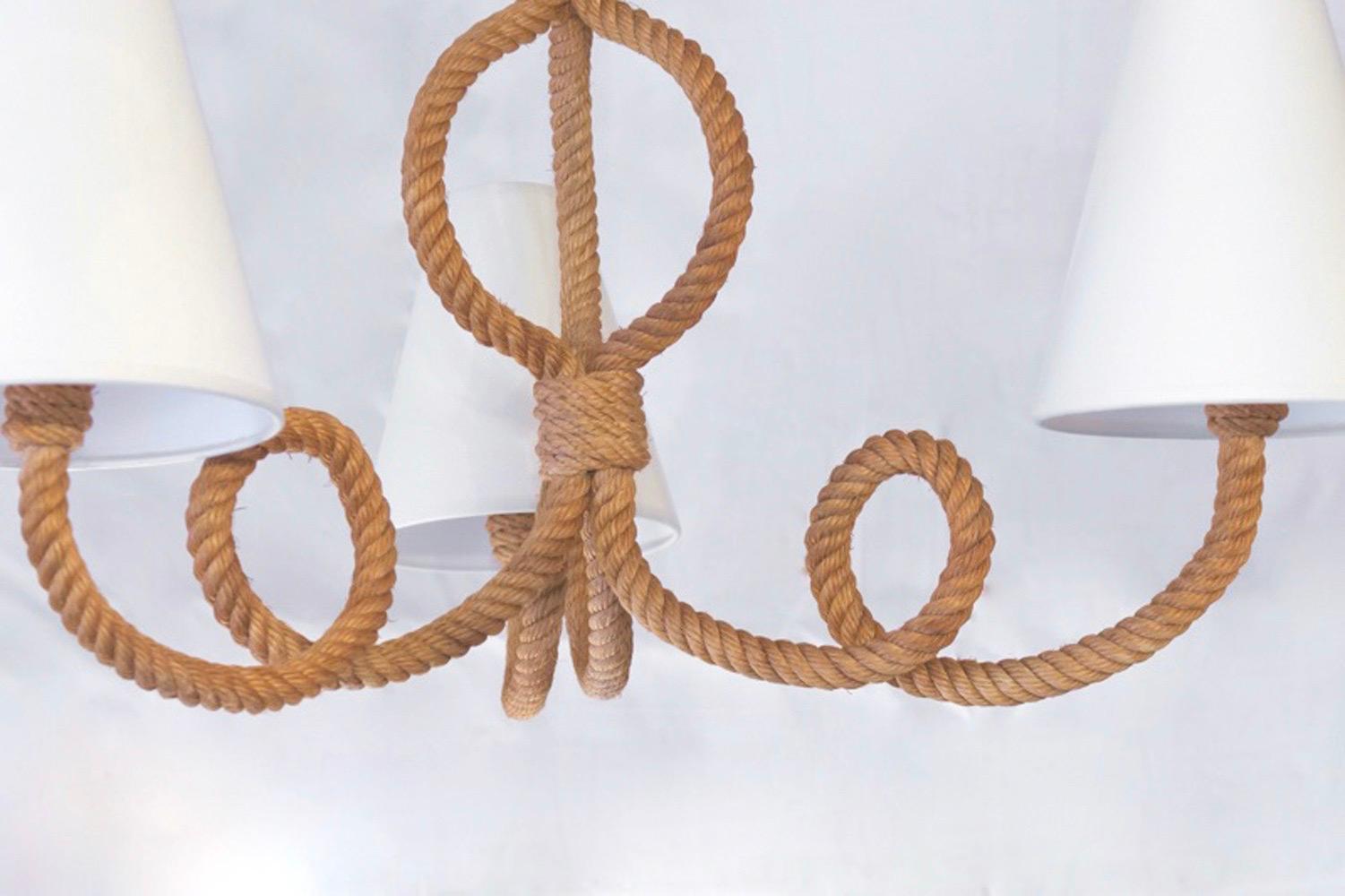 1950s Audoux & Minet rope chandelier
The structure of the chandelier includes three curved arms woven together to form the central arm of the chandelier. Off-white cotton shades matched to the originals. Four-light bulbs.

Adrien Audoux and Frida