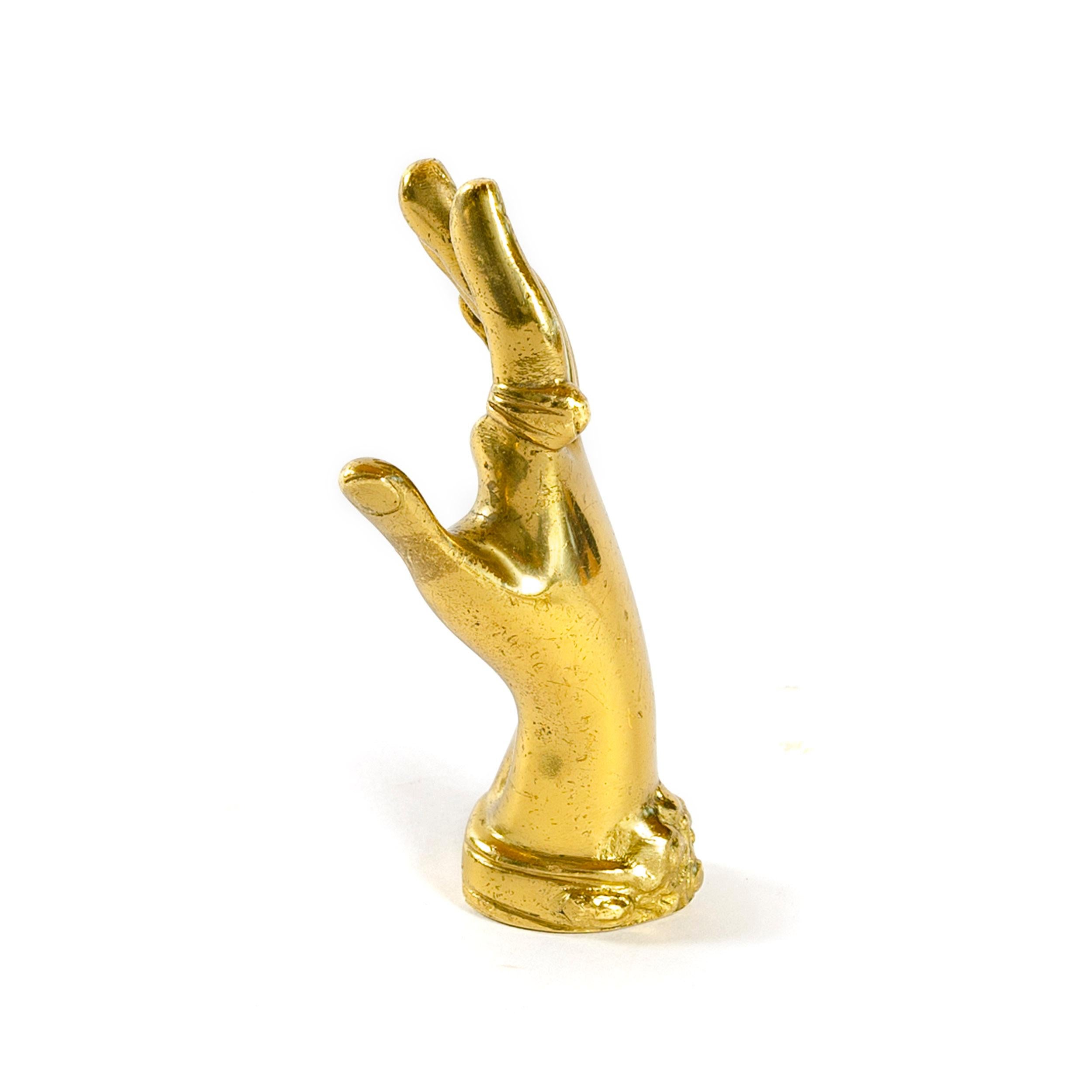 An elegant heavy solid brass 'hand' paperweight.