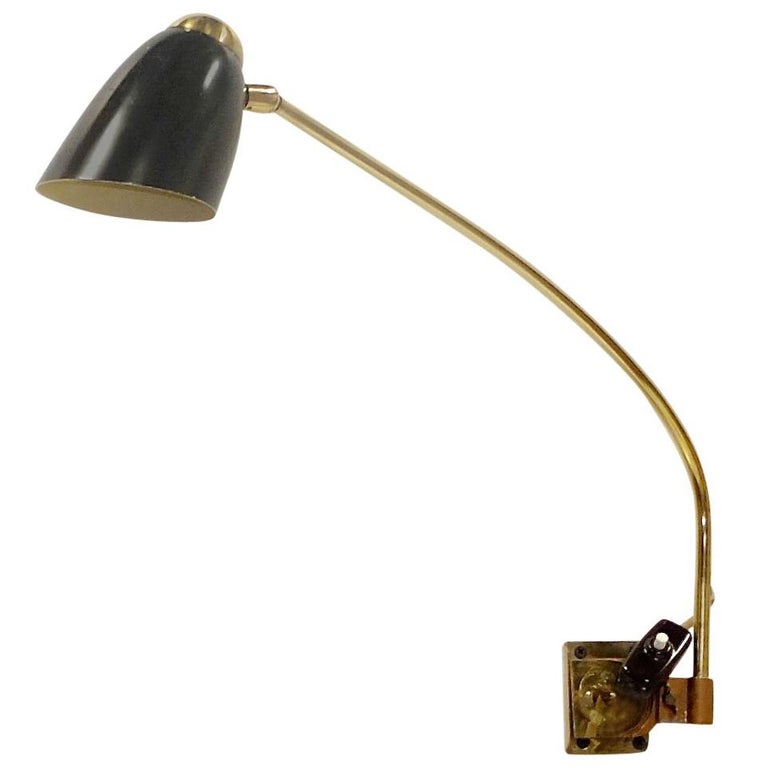 Industrial modern articulating swing wall light with parabolic shade