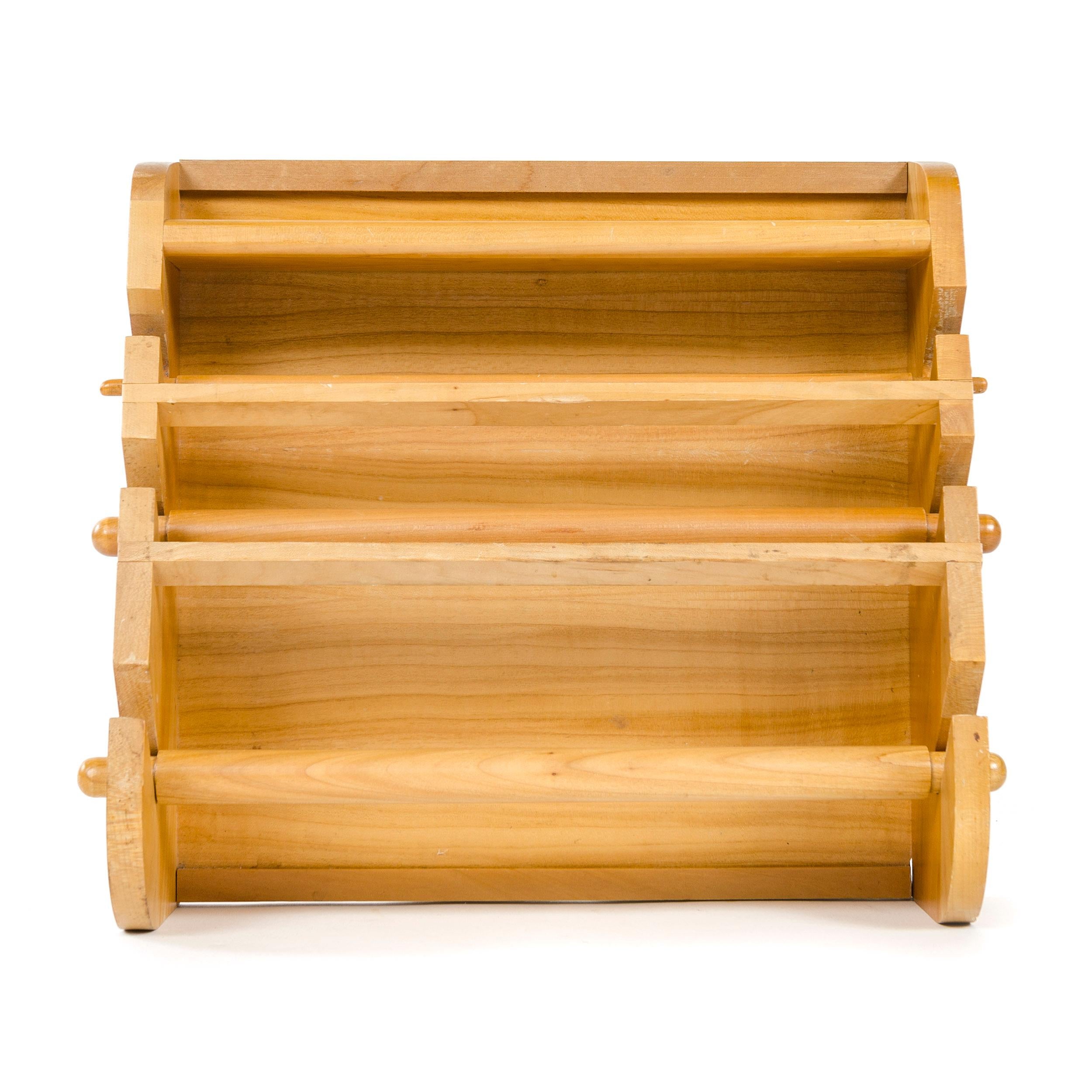 A three-tiered wall mounted wooden towel rack with top shelf and removable rods.