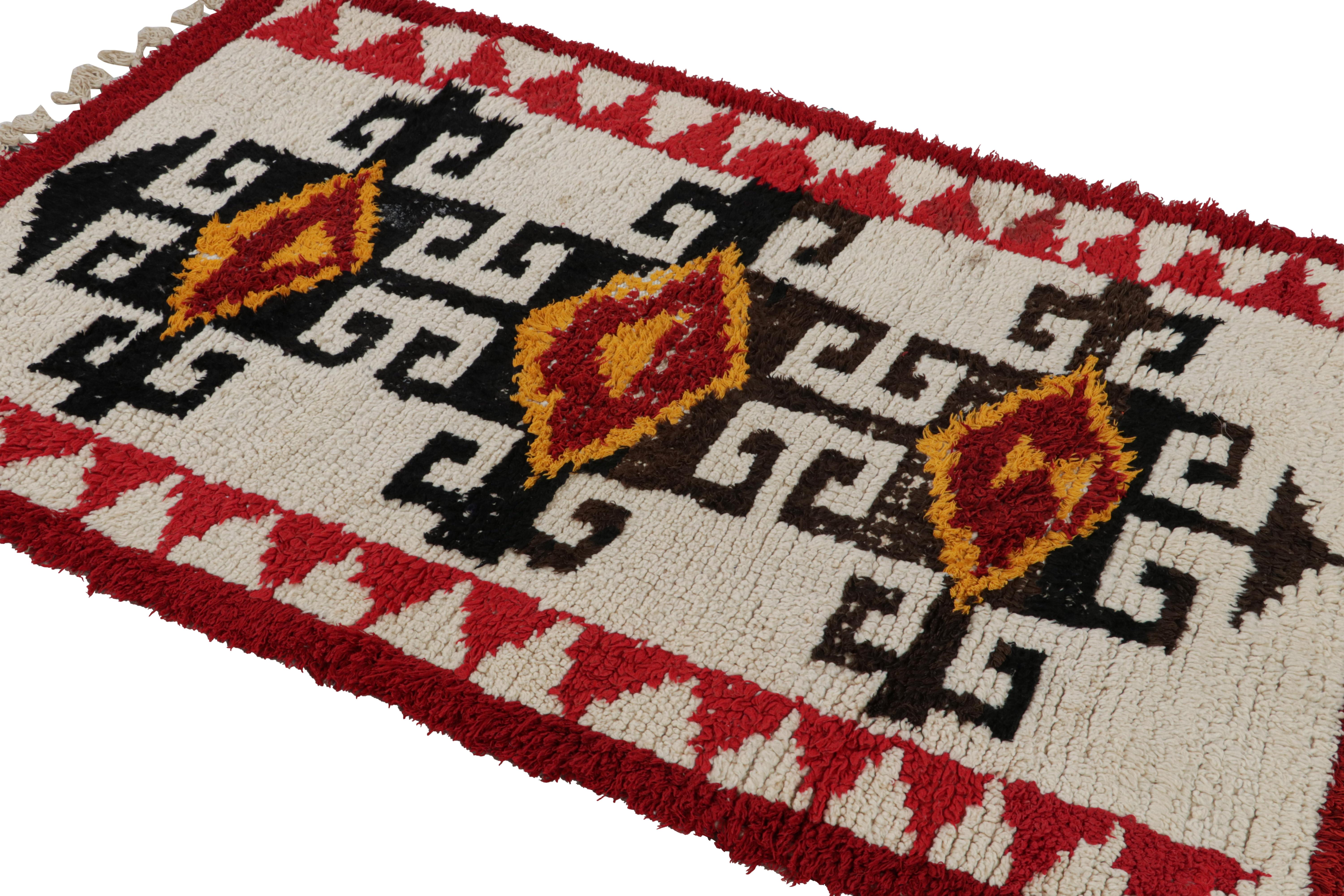 Hand-knotted in wool circa 1950-1960, this vintage 4x6 Moroccan rug is believed to hail from the Azilal tribe. 

On the Design: 

This rug makes a bold statement with prominent tribal motifs in black, red and gold. This powerful play of colors is
