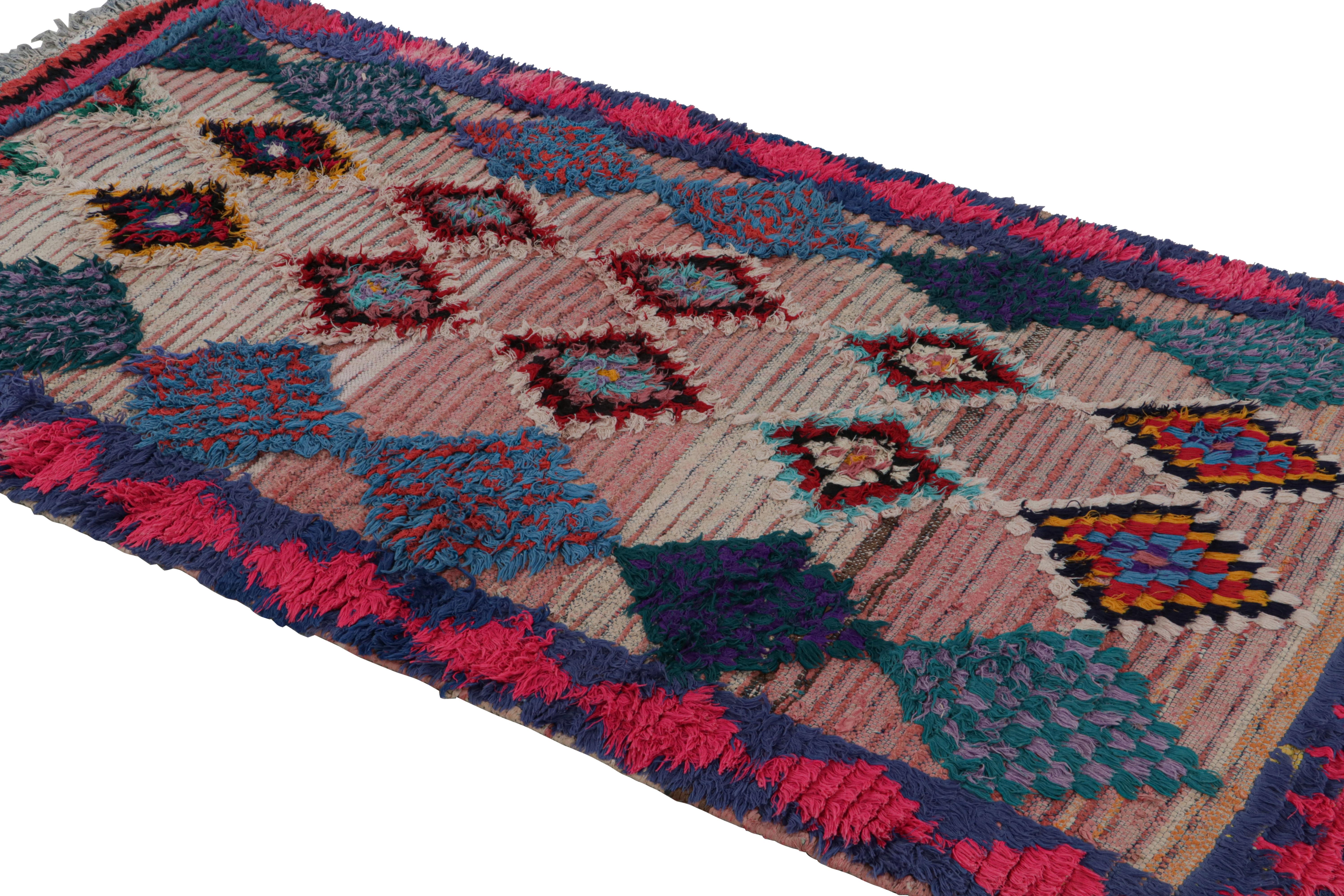 Hand-knotted in wool circa 1950-1960, this vintage 4x8 Moroccan rug is believed to hail from the Azilal tribe. 

On the Design: 

This rug enjoys pink and blue diamond patterns with red juxtapositions. Keen eyes will further admire its healthy