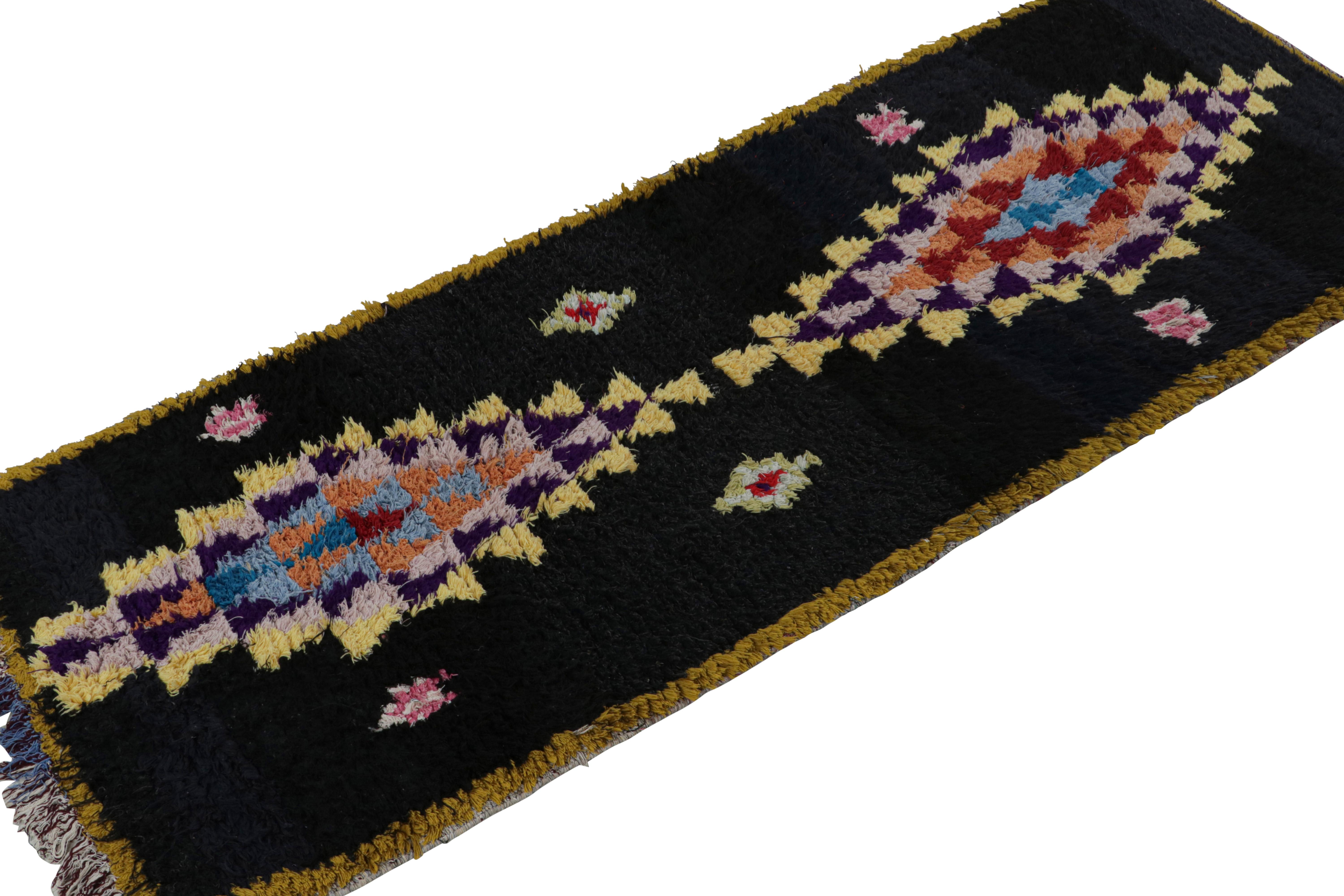 Hand-knotted in wool circa 1950-1960, this vintage 3x7 Moroccan runner is believed to hail from the Azilal tribe. 

On the Design: 

This runner is especially rare for being among the few Moroccan tribal rug provenance to favor black like this open